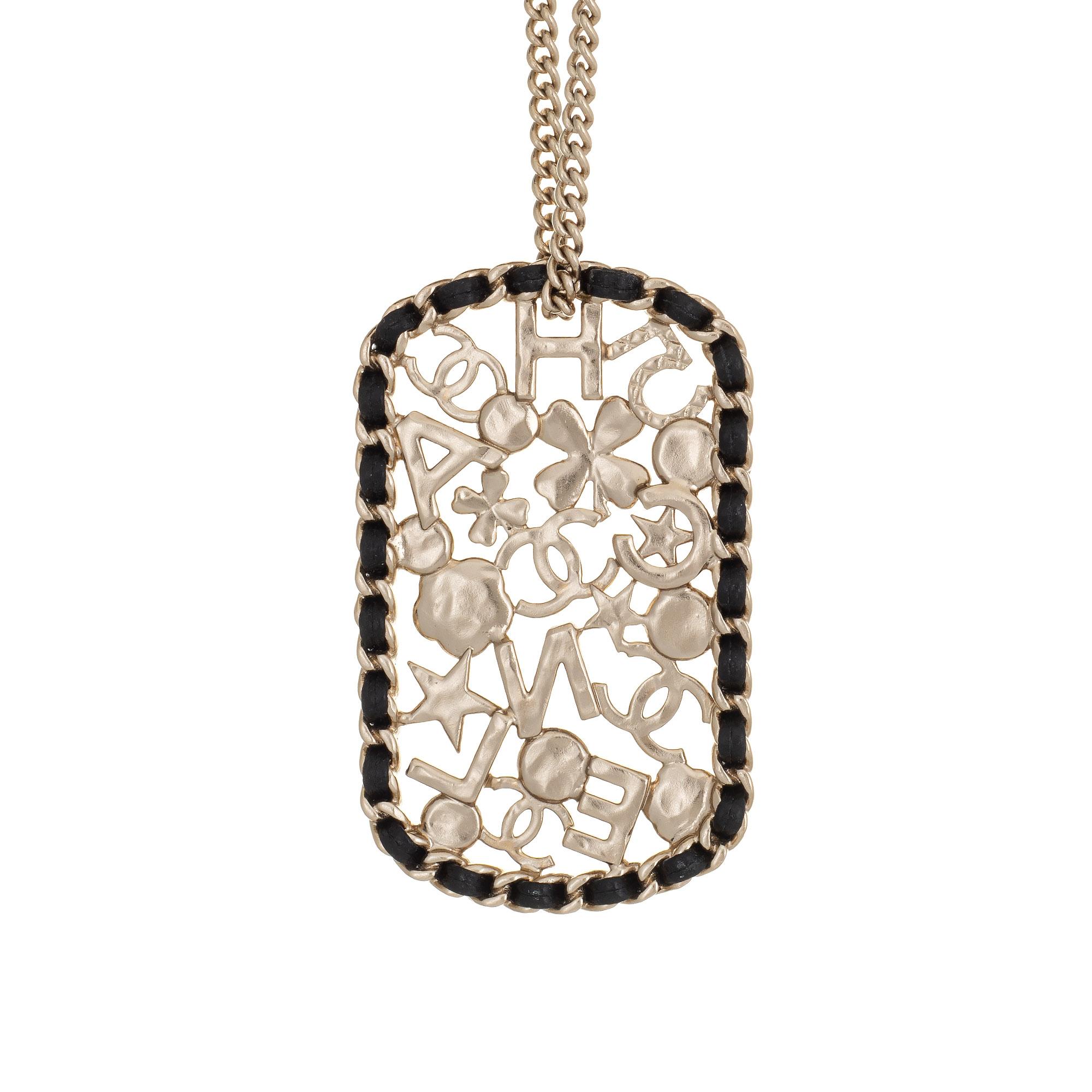 Pre-owned Chanel pendant necklace crafted in light yellow gold-tone (circa 2020). 

The large square pendant features a mosaic of CC logos, camellia, clover, 5, star, and crystal 