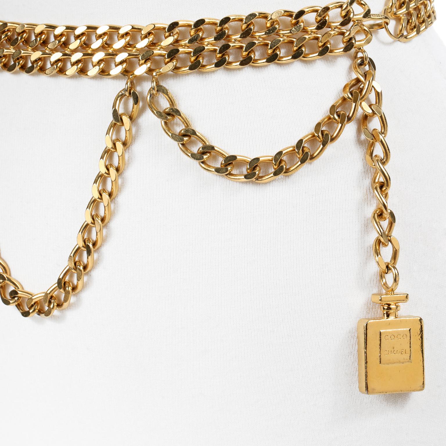 This authentic Chanel Perfume Bottle Triple Chain Belt is in beautiful condition.  Substantial double layer of gold tone linked chain with a third draped chain.  Gold COCO CHANEL perfume bottle dangles from the end.  Hook closure.  Measurements:  