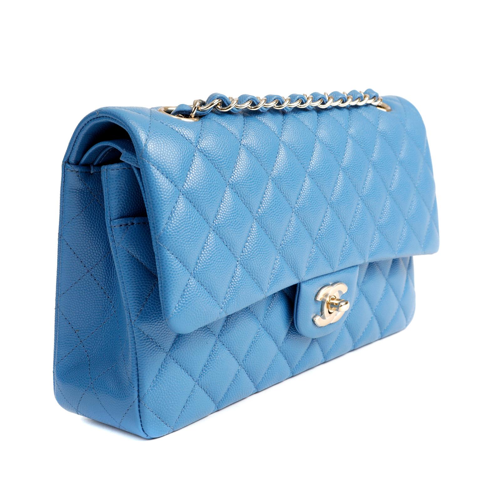 This authentic Chanel Periwinkle Caviar Leather Medium Classic Flap Bag is in pristine unworn condition, never carried.  A key piece in any sophisticated wardrobe, the Classic Flap is one of the most sought-after Chanel styles produced.
Durable and