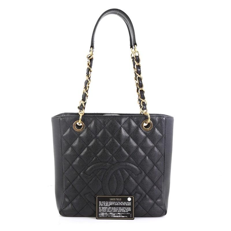 This Chanel Petite Shopping Tote Quilted Caviar, crafted from black quilted caviar leather, features a stitched CC logo, dual woven-in leather chain straps with leather pads, exterior back slip pocket, and gold-tone hardware. Its magnetic snap