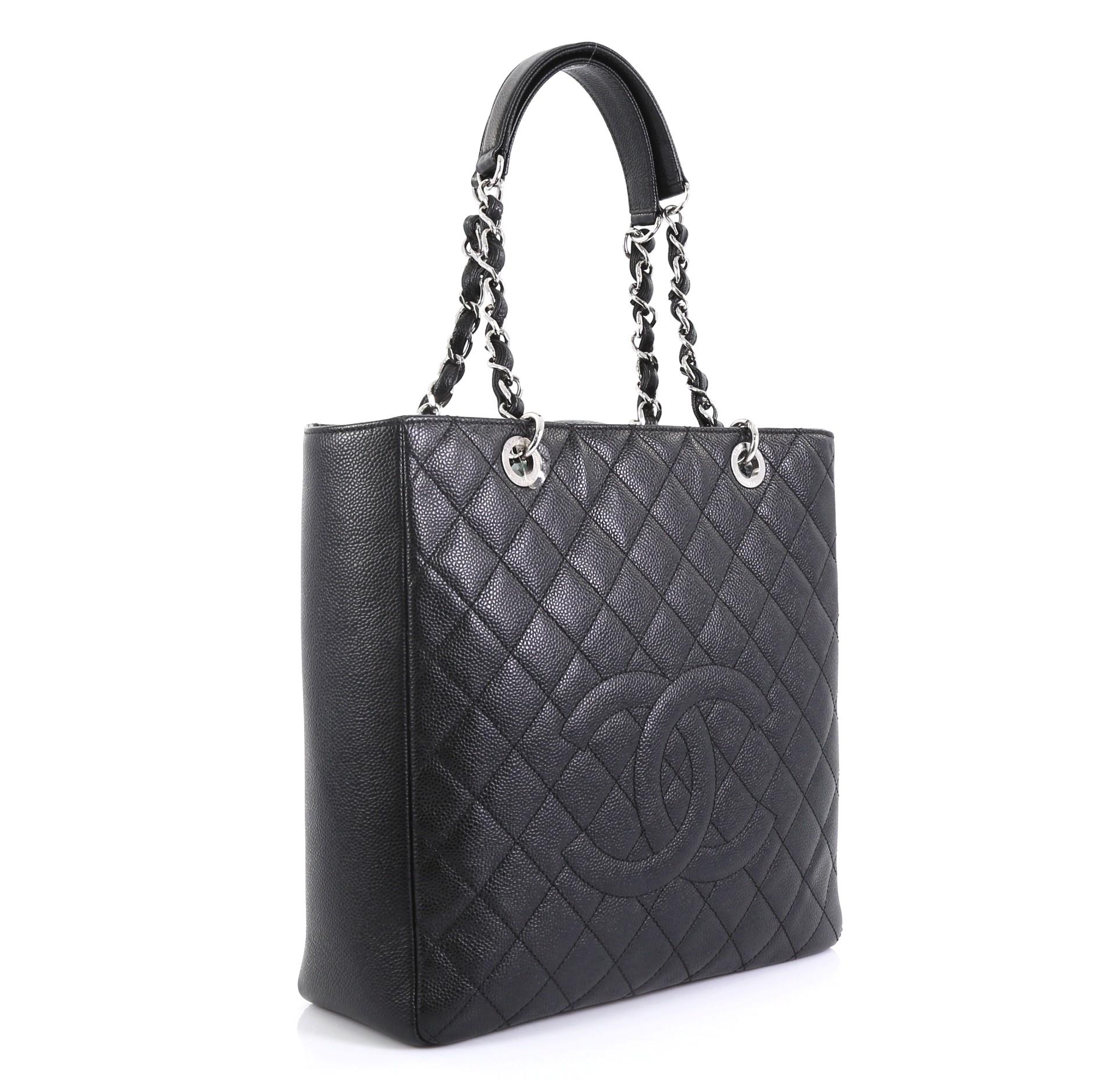 This Chanel Petite Shopping Tote Quilted Caviar Large, crafted from black quilted caviar leather, features dual woven-in leather chain straps with leather pads, stitched CC logo, exterior back slip pocket, and silver-tone hardware. Its magnetic snap