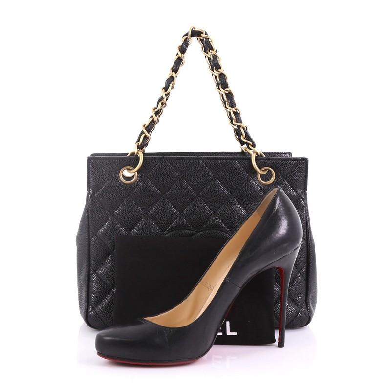 This Chanel Petite Timeless Tote Quilted Caviar, crafted in black quilted caviar leather, features dual woven-in leather chain link straps, interlocking CC logo, and aged gold-tone hardware. Its zip closure opens to a black leather interior with