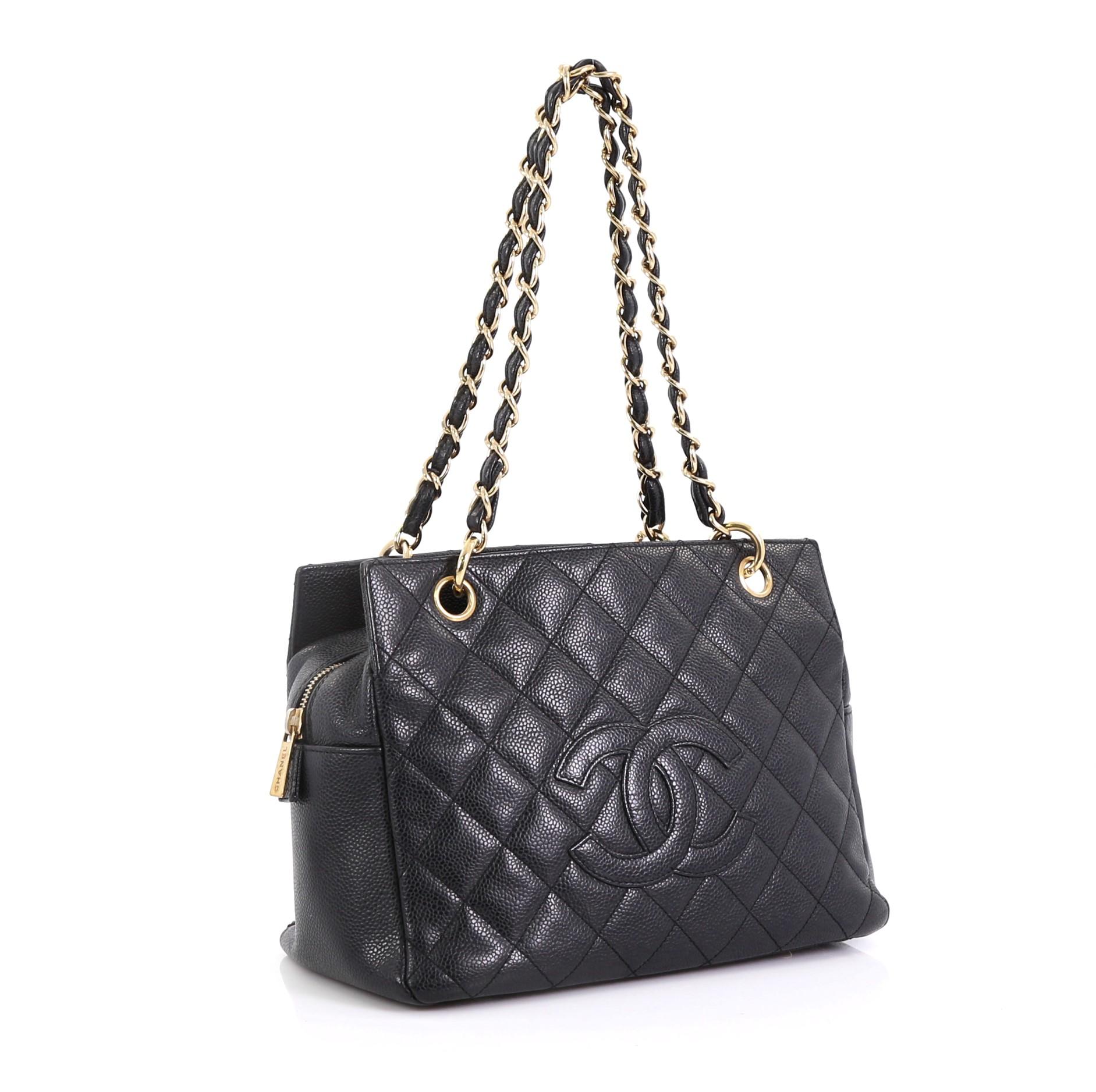 This Chanel Petite Timeless Tote Quilted Caviar, crafted in black quilted caviar leather, features dual woven in leather chain link straps, interlocking CC logo, and gold-tone hardware. Its zip closure opens to a black fabric interior with side zip