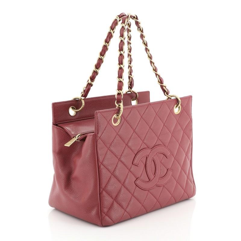 This Chanel Petite Timeless Tote Quilted Caviar, crafted in pink quilted caviar leather, features dual woven-in leather chain link straps, interlocking CC logo, and matte gold-tone hardware. Its zip closure opens to a pink leather interior with side