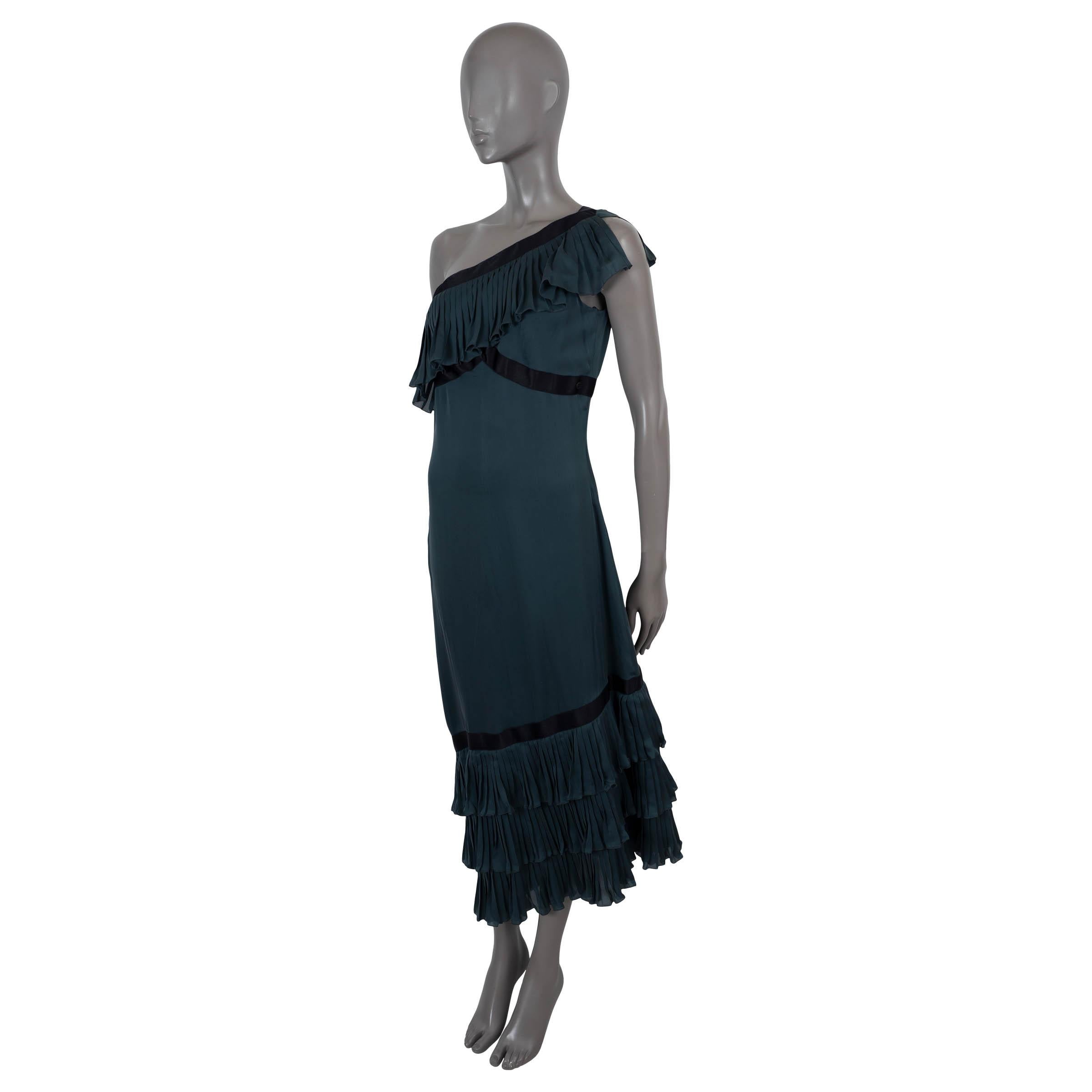 100% authentic Chanel one-shoulder cocktail dress in dark petrol blue silk (100%). Features pleated trim with black satin band and asymmetric hem. Opens with a concealed zipper and is unlined. Has been worn and is in excellent condition. 

2006