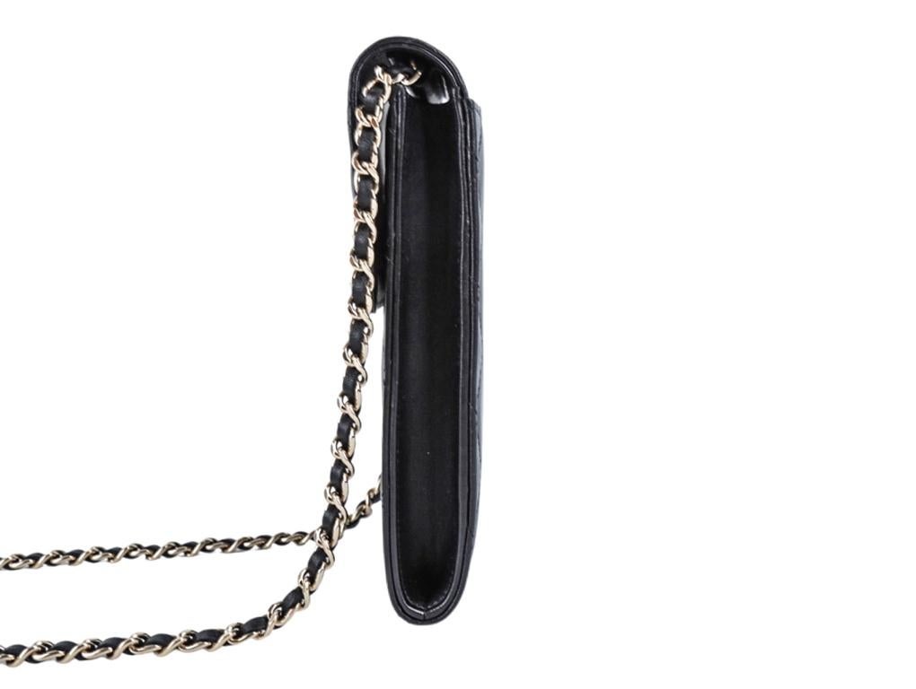 A lovely Chanel Phone Holder for sale or actually use as a nano cross-body bag. Made from black lambskin leather with Black/White CC logo detail on the front. Purchased, stored and never used. Plastic covering is still attached to the front CC logo