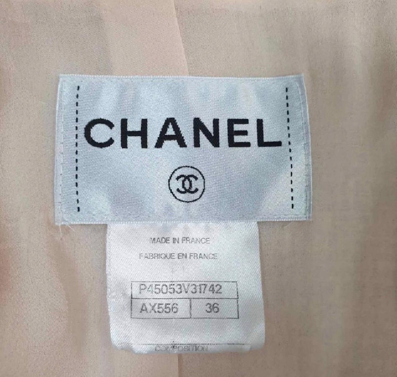 Chanel Spring Cruise 2013 Pink Boucle Fringe Military Style Pea Coat 3/4 Jacket.

Size FR 36

Intricate lace trim, fringe edging, iconic Chanel boucle, Chanel enamel and gold tone filigree buttons.

From the 2013 resort / cruise runway collection.