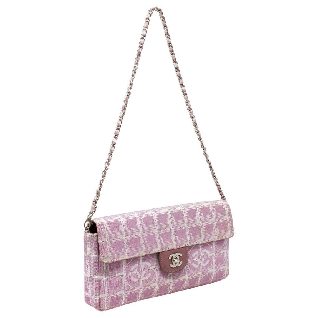 This spirited Chanel bag from the year 2000 is so fun, chic, and unique! Rendered in the iconic Chanel Travel Ligne logo pattern on canvas, in a gorgeous pink tone, with leather trimmings, and the most perfect shoulder drop length. The CC turn-lock