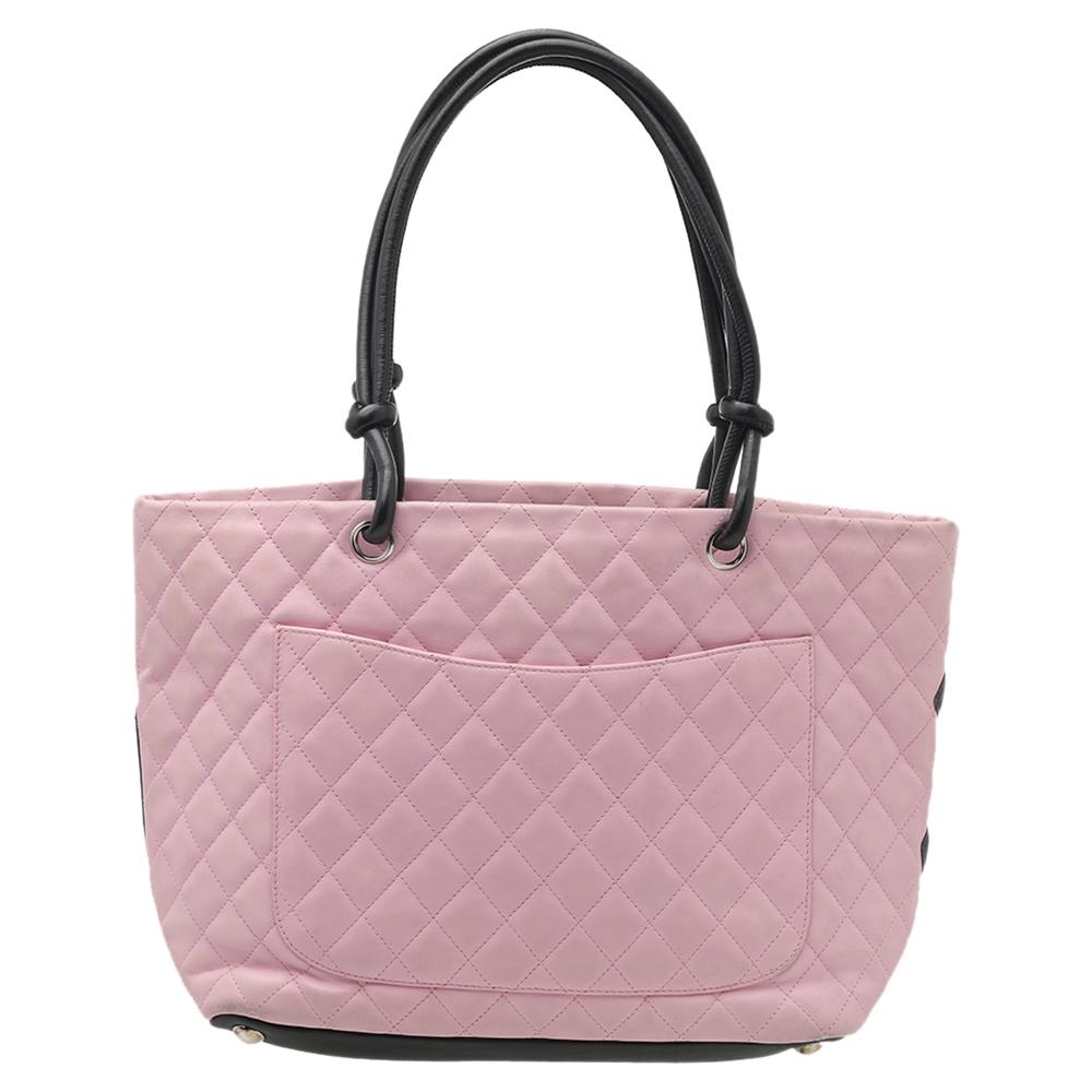 From Chanel’s Ligne Cambon collection, this extremely sophisticated bag is certainly one of the most popular among fashionistas. Crafted out of quilted leather in pink, the exterior features a CC logo in black leather. It has leather top handles.
