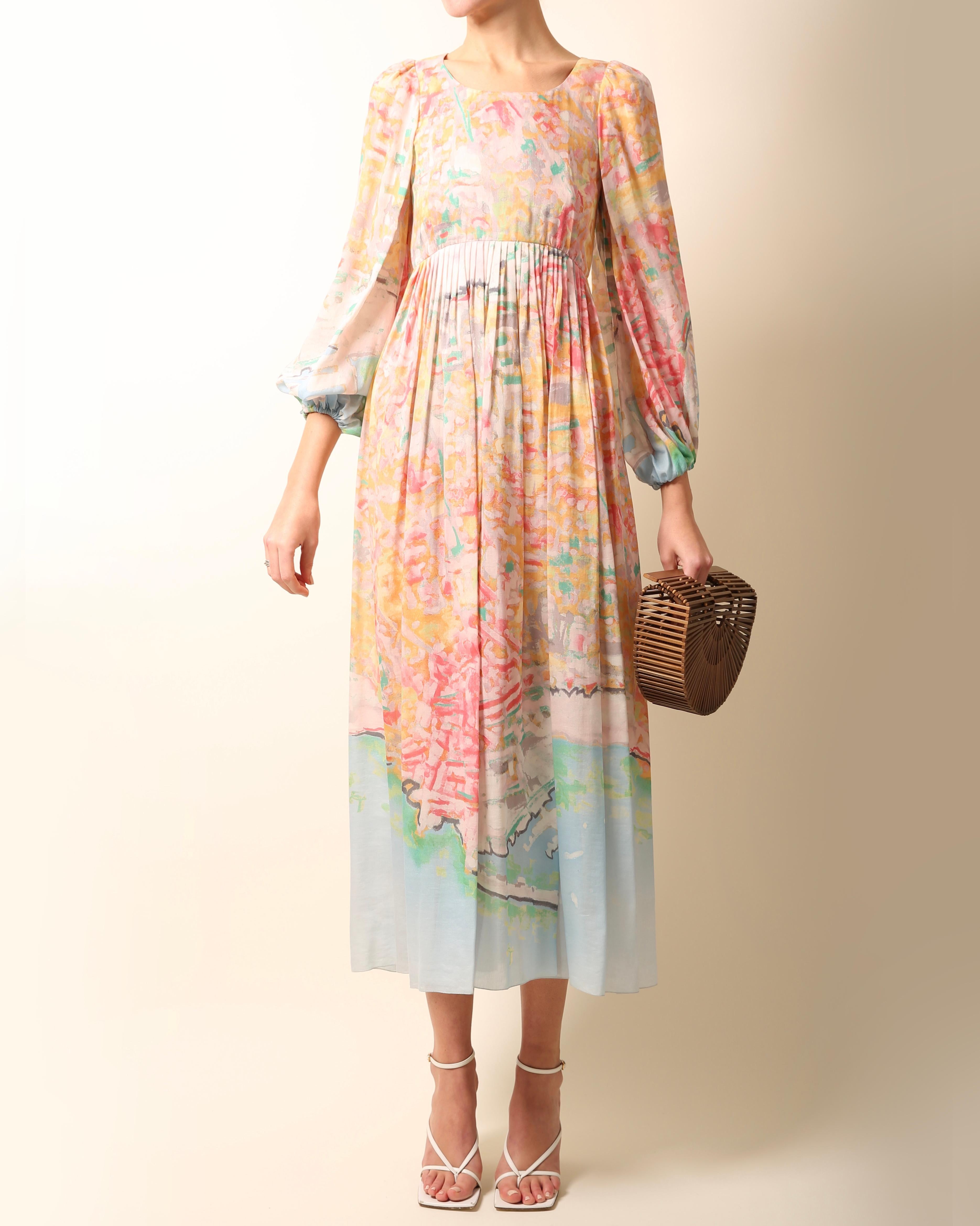 Chanel Resort 2011
Rare babydoll style midi length dress in a beautiful array of pastel colours
Abstract watercolour style print
Sleeves are ruched at the cuff creating a balloon effect
Free flowing skirt with pleat detail
Cinched in waist
Concealed