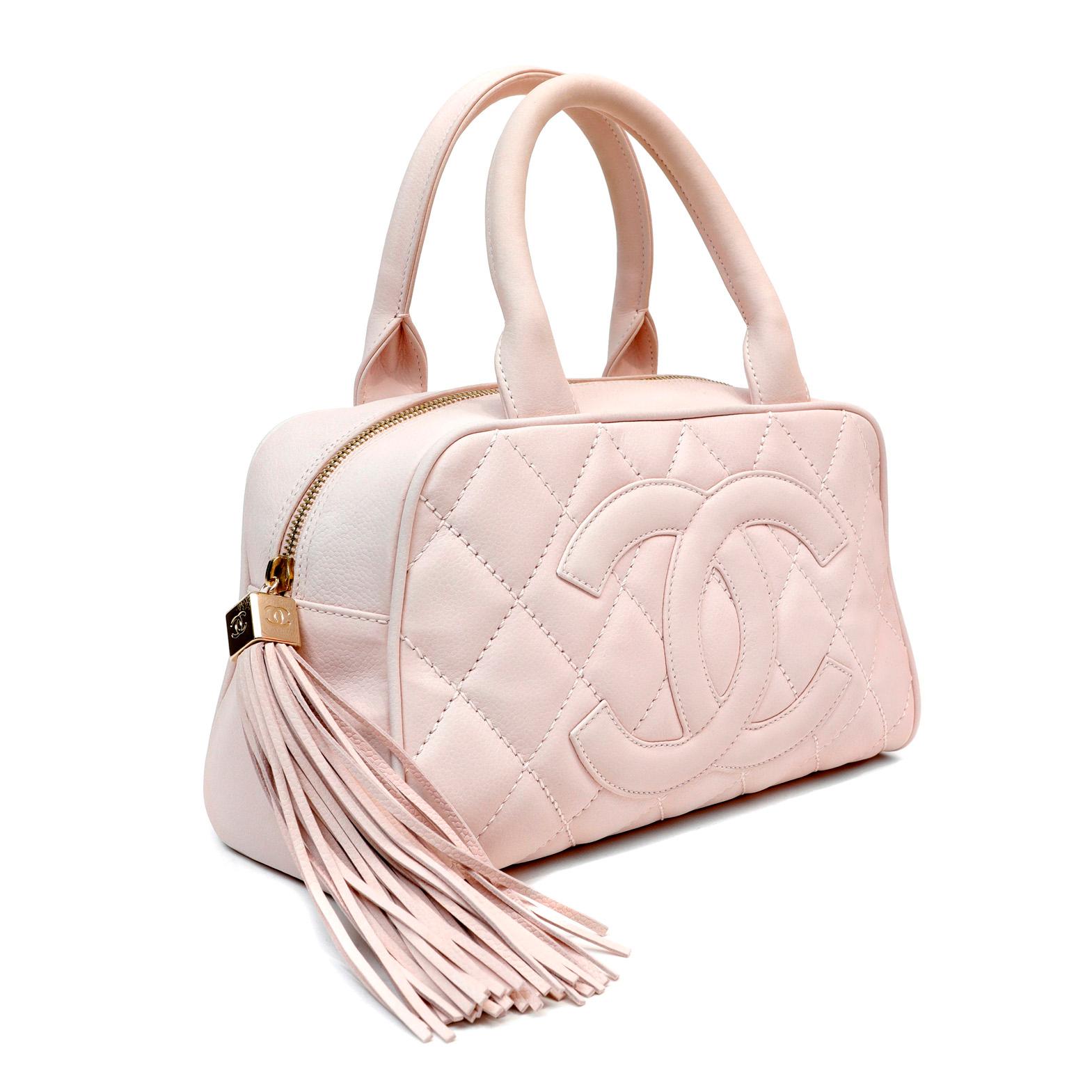 This authentic Chanel Pink Brushed Caviar Mini Tote is in excellent plus condition.  Lovely and demure mini silhouette in feminine ballerina pink with an oversized leather tassel accent. Signature Chanel diamond stitched pattern with large