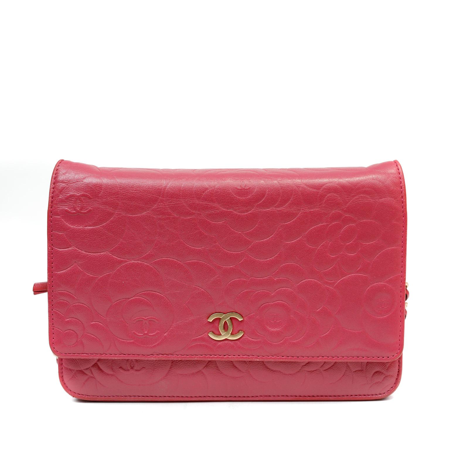This authentic Chanel Rose Pink Camellia Embossed Leather Wallet on a Chain is in excellent plus condition.  The beloved WOC, or Wallet on a Chain, is a classic style that elevates any ensemble while practically carrying all the essentials. Rose