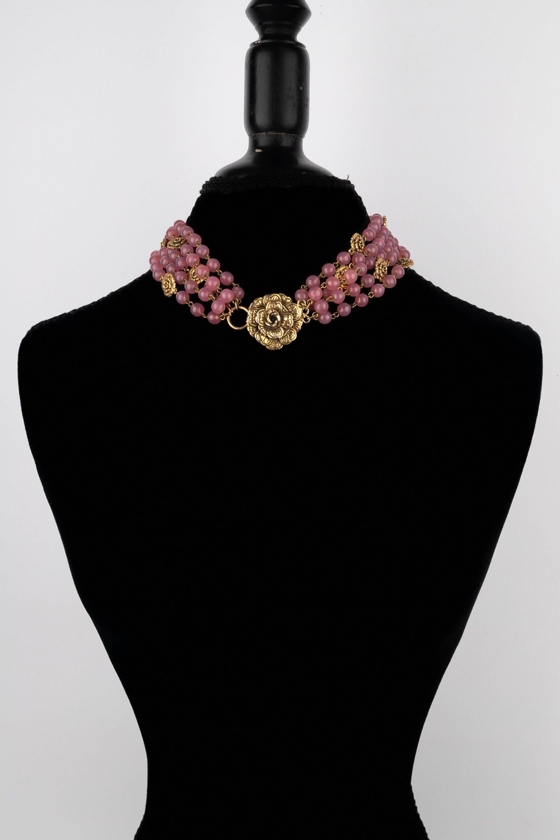 Chanel - (Made in France) Collana corta in metallo dorato composta da diversi fili di perle di vetro rosa e con una chiusura in metallo dorato che rappresenta una camelia.

Informazioni aggiuntive:
Condizioni: Ottime condizioni
Dimensioni:
