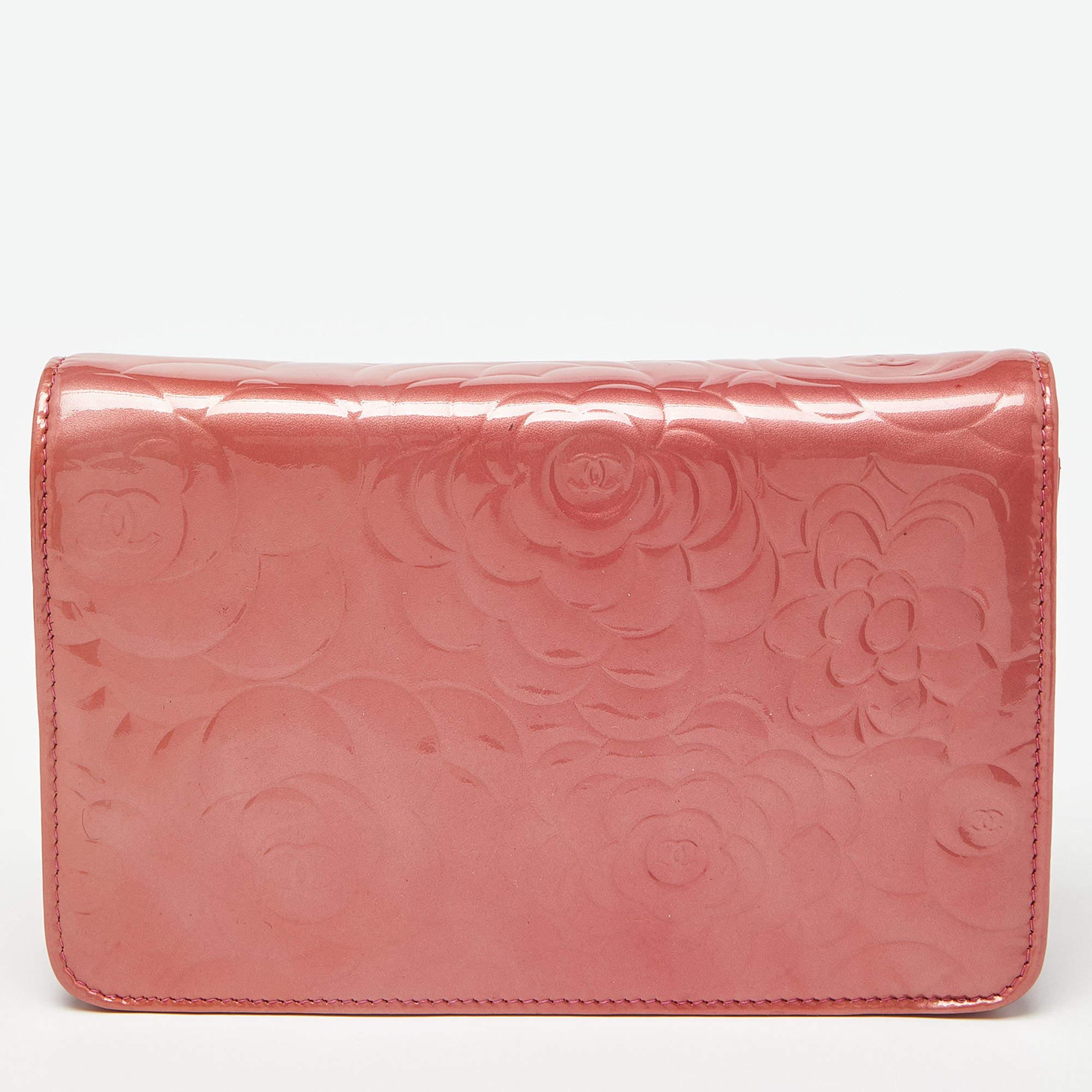 Get the assurance of quality and style that never fades with this Chanel pink Wallet On Chain. It is sewn using patent & leather and the interior has a wallet-like layout with space for cards, cash, and coins. The Chanel WOC is complete with a