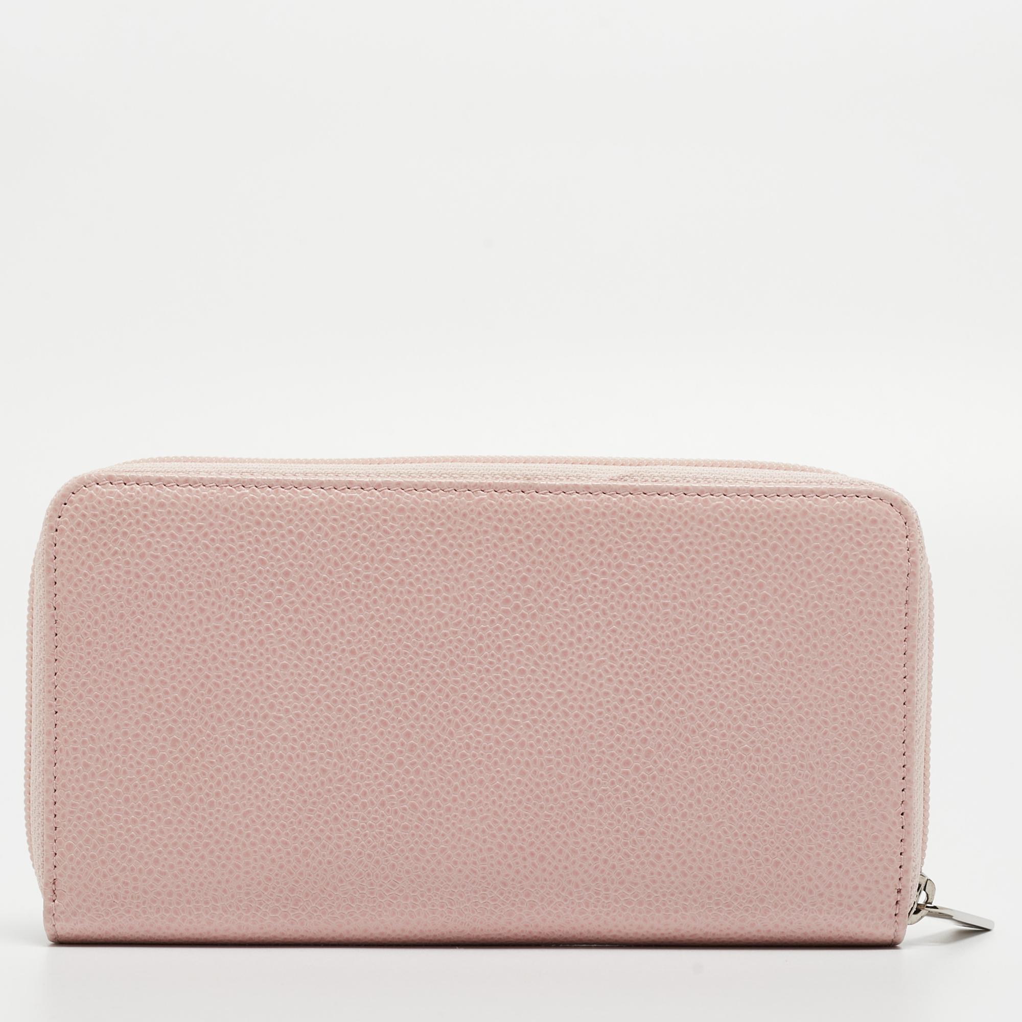 Keep your monetary essentials safely in this wallet from the House of Chanel. It is made from pink caviar leather on the exterior, with an embossed CC logo decorating the front. The zip-around feature opens to a leather-fabric interior. This Chanel