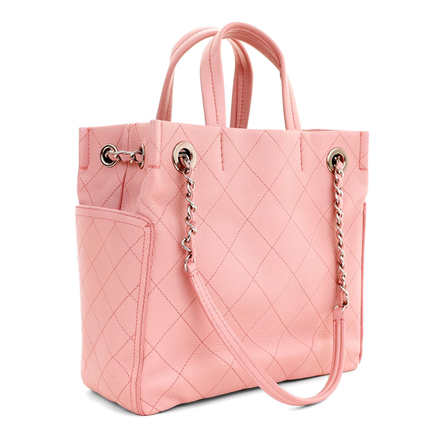 This authentic Chanel Pink Caviar Leather Day Tote is in pristine condition.  Carried by the short handles or the longer shoulder straps, this chic carryall is a must have.
Soft pink caviar leather is textured and durable.  Large side pockets gain