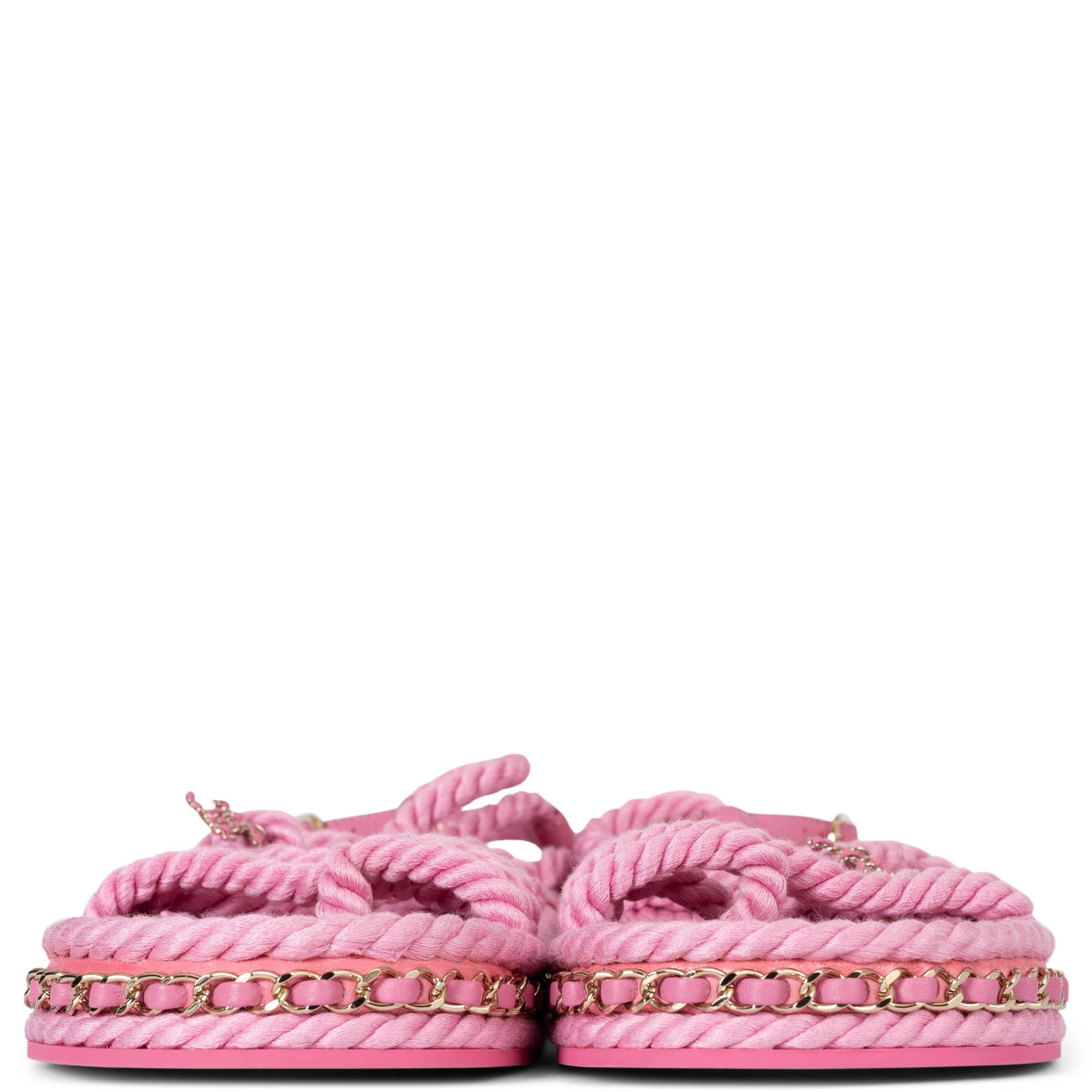 These 100% authentic Chanel pink cord sandals exude elegance, combining comfort, style, and sophistication. Featuring a chic beige gold-tone chain detail along the sole, these sandals showcase versatile colors and superior craftsmanship, making them