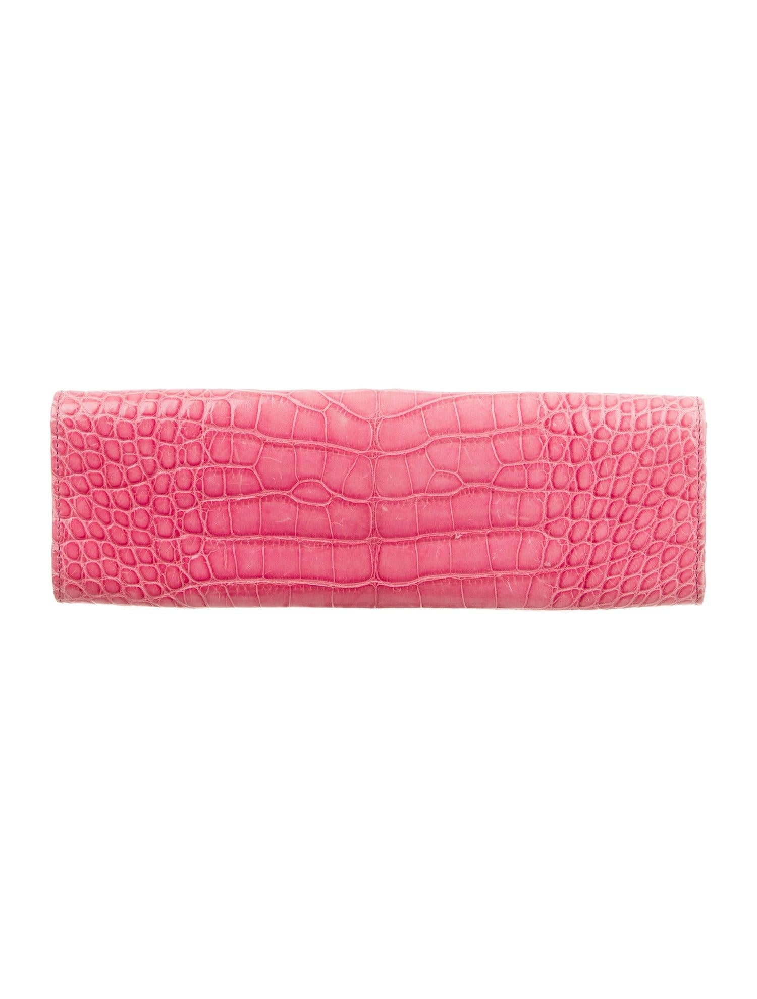 Chanel Pink Crocodile Exotic Leather Gold Pearl Envelope Evening Clutch Flap Bag

Crocodile 
Gold-tone hardware
Faux pearl
Leather lining 
Pull-through closure
Date code present
Measures 10