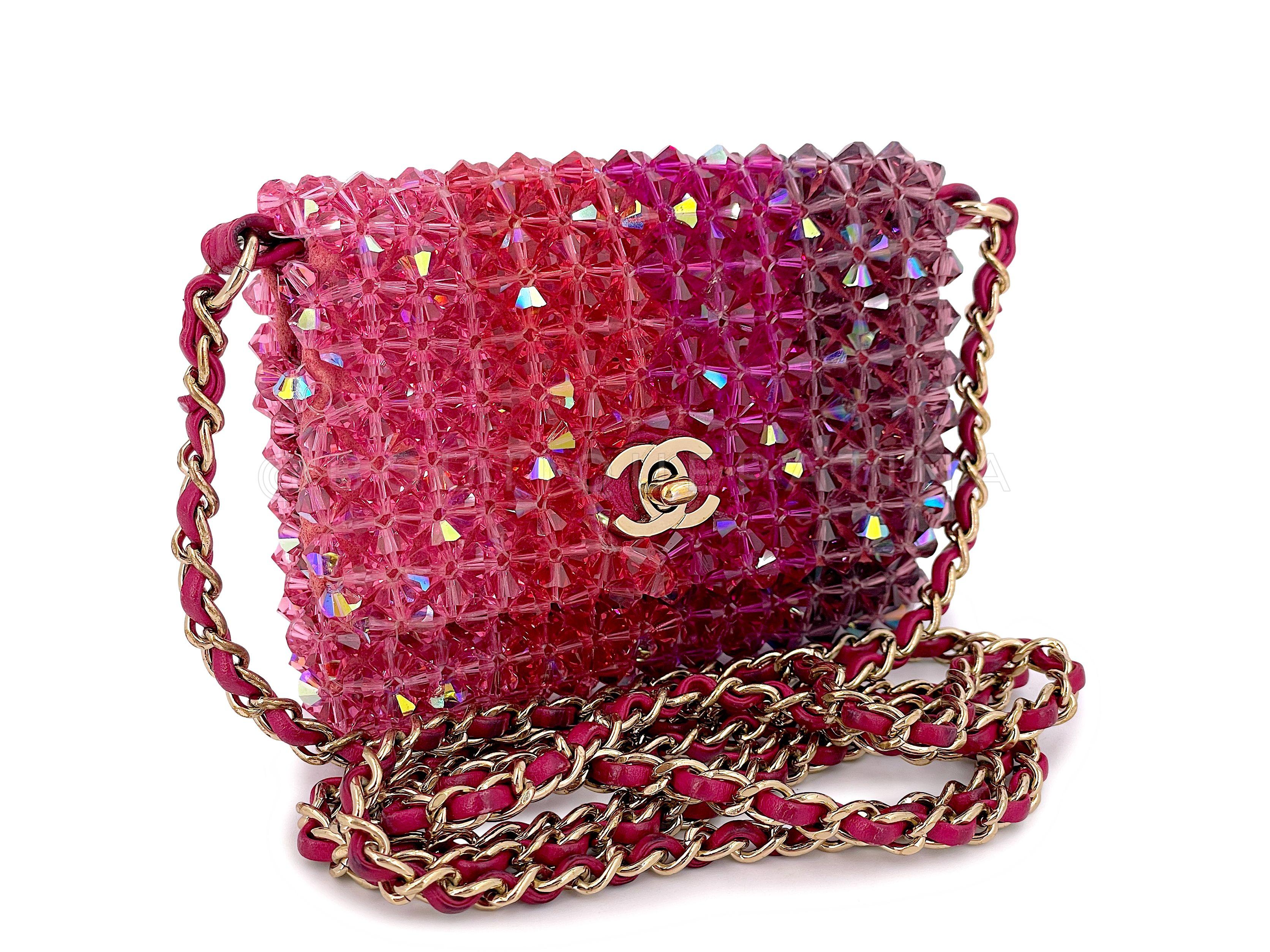 Store item: 67187
A very special runway piece from 2020, a micro mini crossbody with woven chain, varied pink-hued pyramid shaped crystals with iridescent/holographic overlay with a CC turnlock flap.

Does not fit a phone. 

In pink iridescent