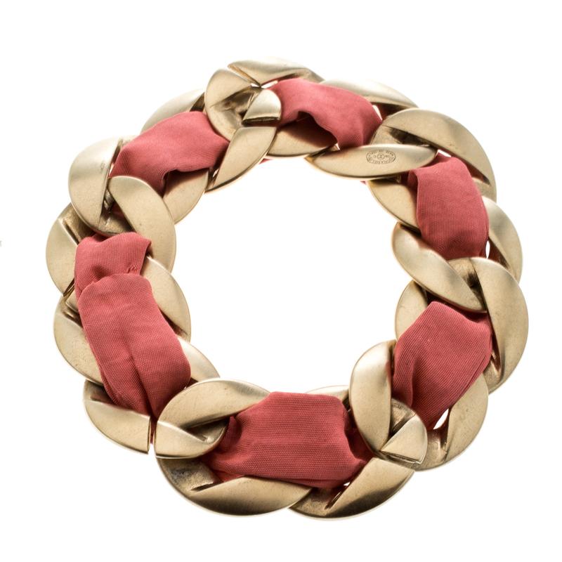 Well-made accessories have the power to enhance any outfit. This bracelet by Chanel is so pretty, you'll love having it around your wrist. The exquisite creation is crafted from gold-tone metal and styled to resemble a chain, while a band of pink