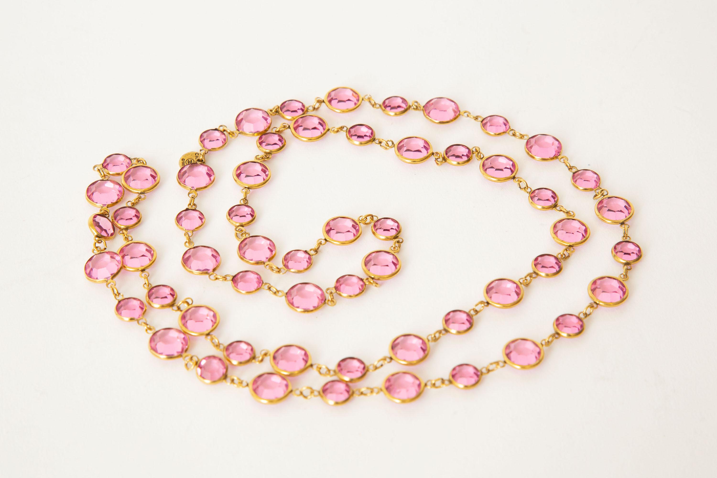This ever so chic hot pink Chanel sautoir necklace is faceted crystals set against gold metal. The tag says Chanel 1981. Pink is a hard color to find in Chanel now. Are you ready for spring and lightness? This is happiness. These can be doubled or