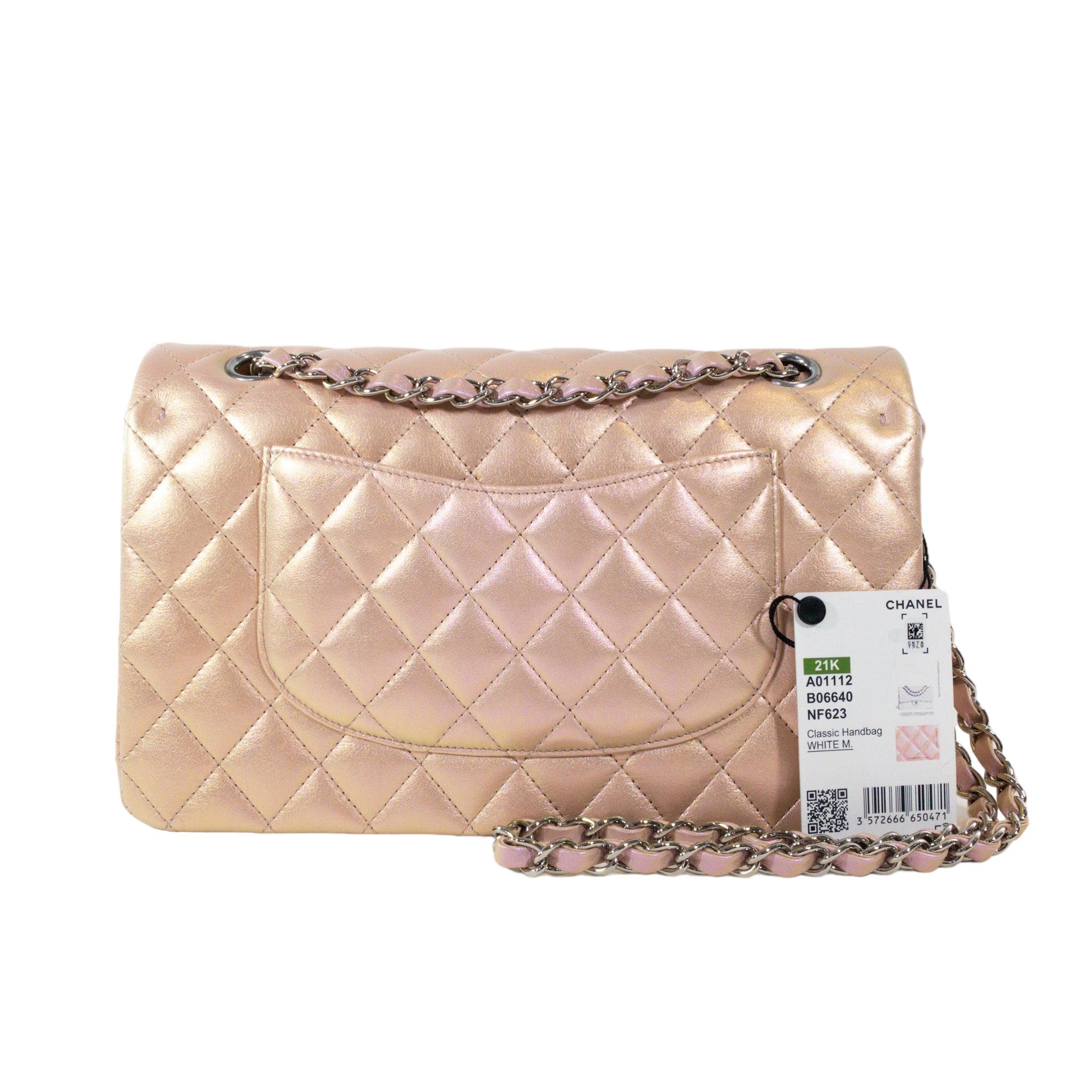 Chanel Pink Iridescent Medium Flap SHW Bag

This is an authentic Chanel Medium Classic Flap. The bag has a flap closure with a Double C logo turn lock. The interior is leather and includes one slip pocket and one zip pocket, it also has one exterior