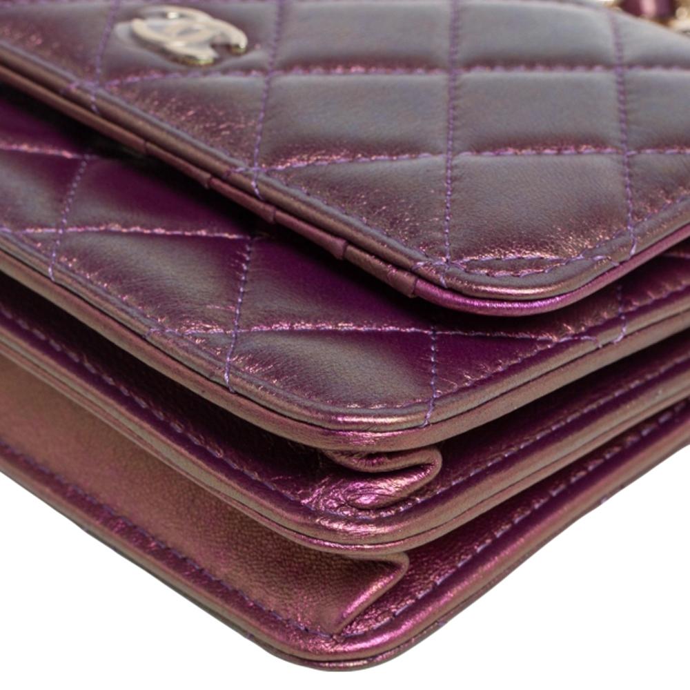 Meticulously crafted from pink iridescent leather, this Chanel Classic Wallet on Chain has a stylish appeal and a durable quality. It has a shoulder chain, the CC logo on the flap, and a well-designed interior featuring card slots and a zip