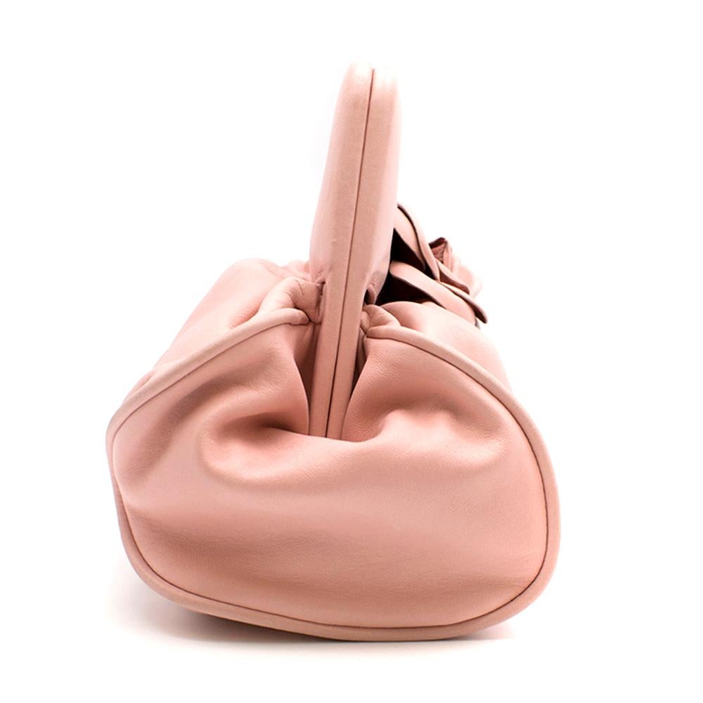 Chanel Pink Leather Camellia Top Handle Bag

- Baby pink leather body
- Signature Camellia flower on the front 
- Clasp closure to the front
- Lining with Chanel monogram 

Please note, these items are pre-owned and may show signs of being stored