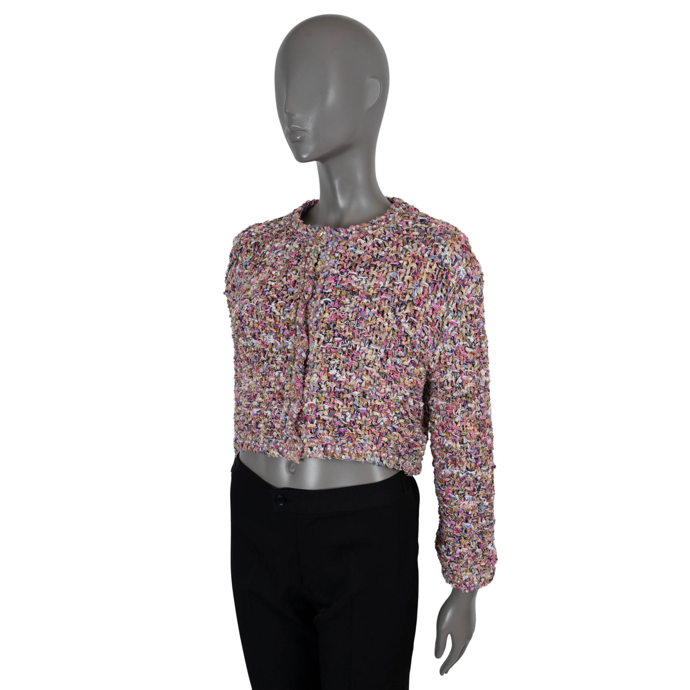 100% autentica giacca Chanel in maglia rosa, viola, beige, giallo e lavanda in poliammide (60%), cotone (15%), abs (13%) e poliestere (12%). Presenta una silhouette boxy senza colletto ed è impreziosito da perle finte. Si chiude con bottoni CC