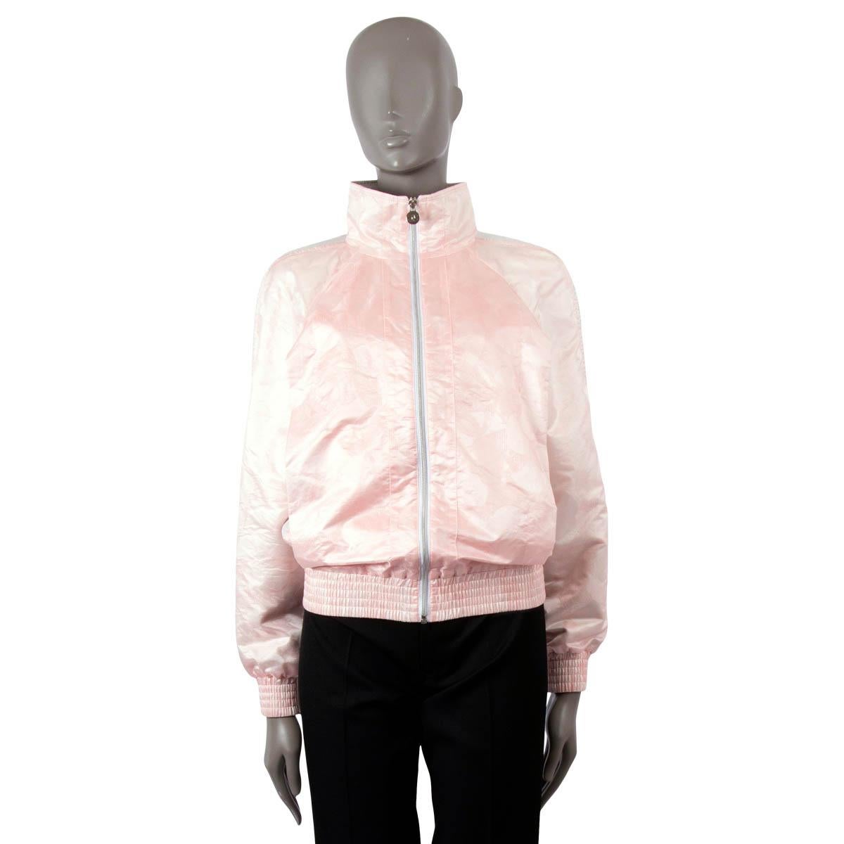 100% authentic Chanel bomber jacket in pink Camellia jacquard toile nylon (68%) and silk (32%). Features raglan sleeves (sleeve measurement take from the neck) with a silver mesh stripe on the sleeves, elastic cuffs and hem. Closes with a zipper on