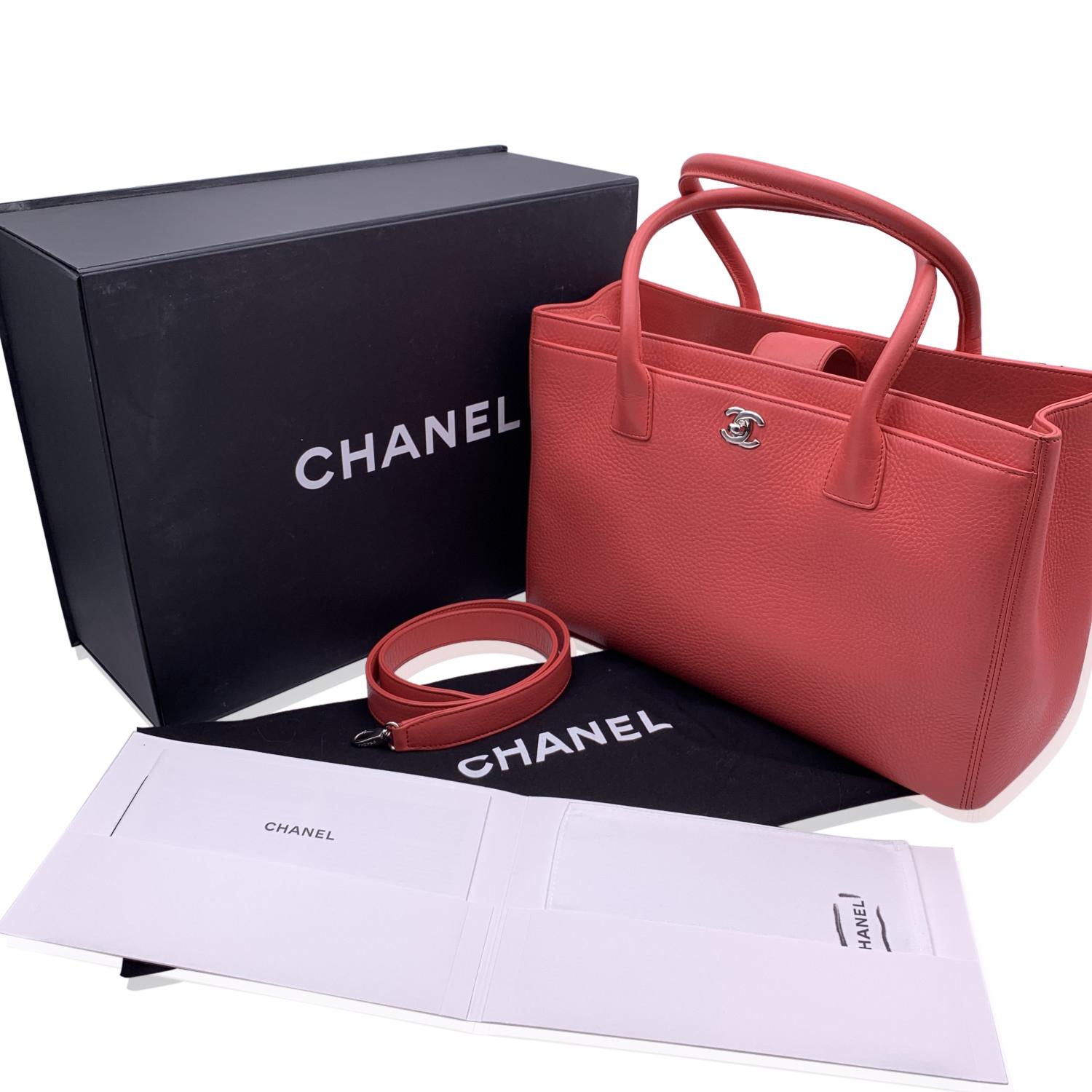 Stunning Chanel 'Executive' Tote Bag in pink pebbled leather. Silver metal CC - CHANEL logo on the front. Double top handles and removable shoulder strap. Double magnetic button closure on top. Front and rear pocket. Grey grosgrain lining. 2 side