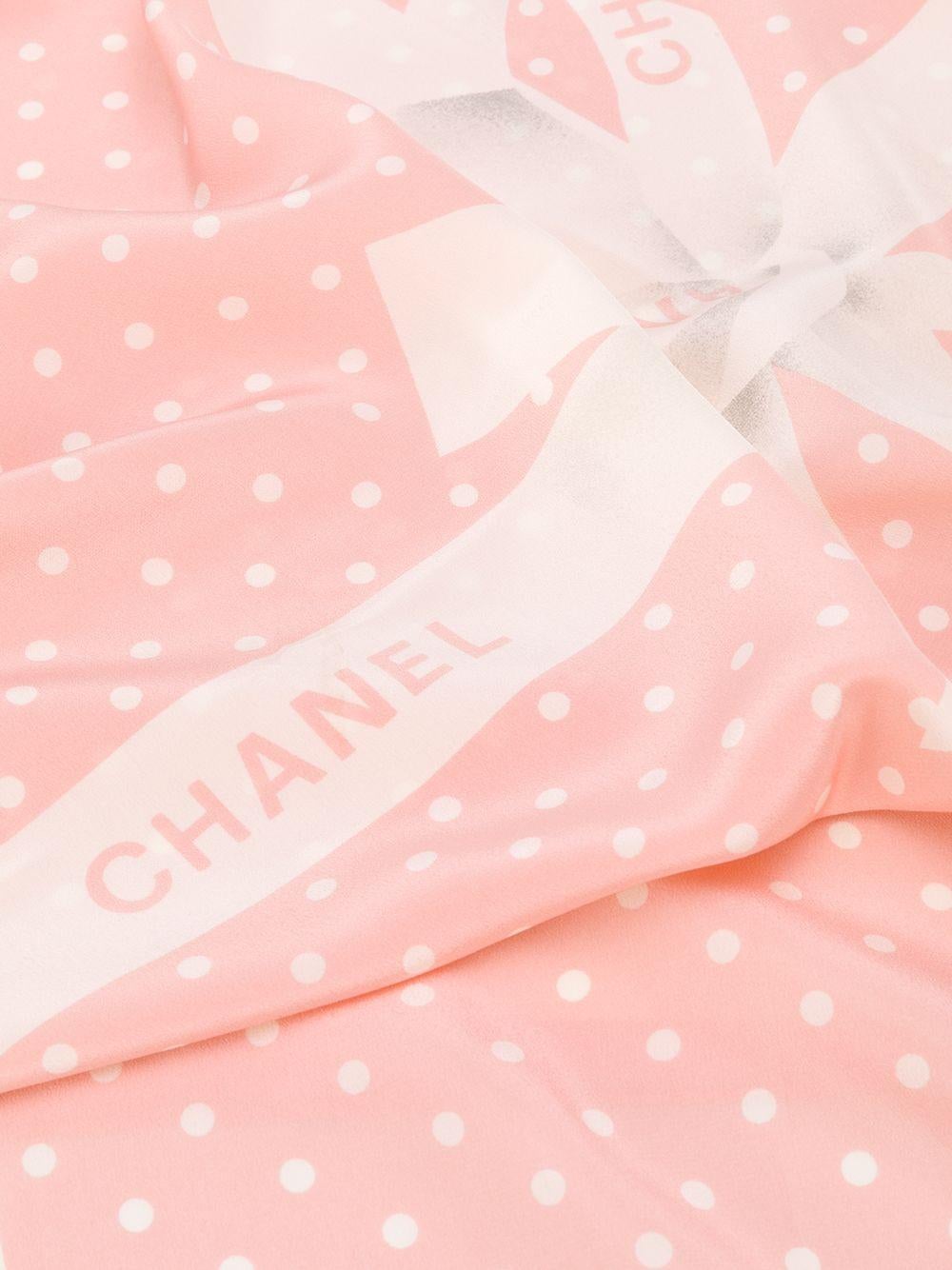 Crafted in France from the finest powder pink silk, pre-owned scarf by Chanel features a lightweight construction, a square shape and a contrasting, all-over white polka dot print. For an added touch of sophistication, the piece is decoratively