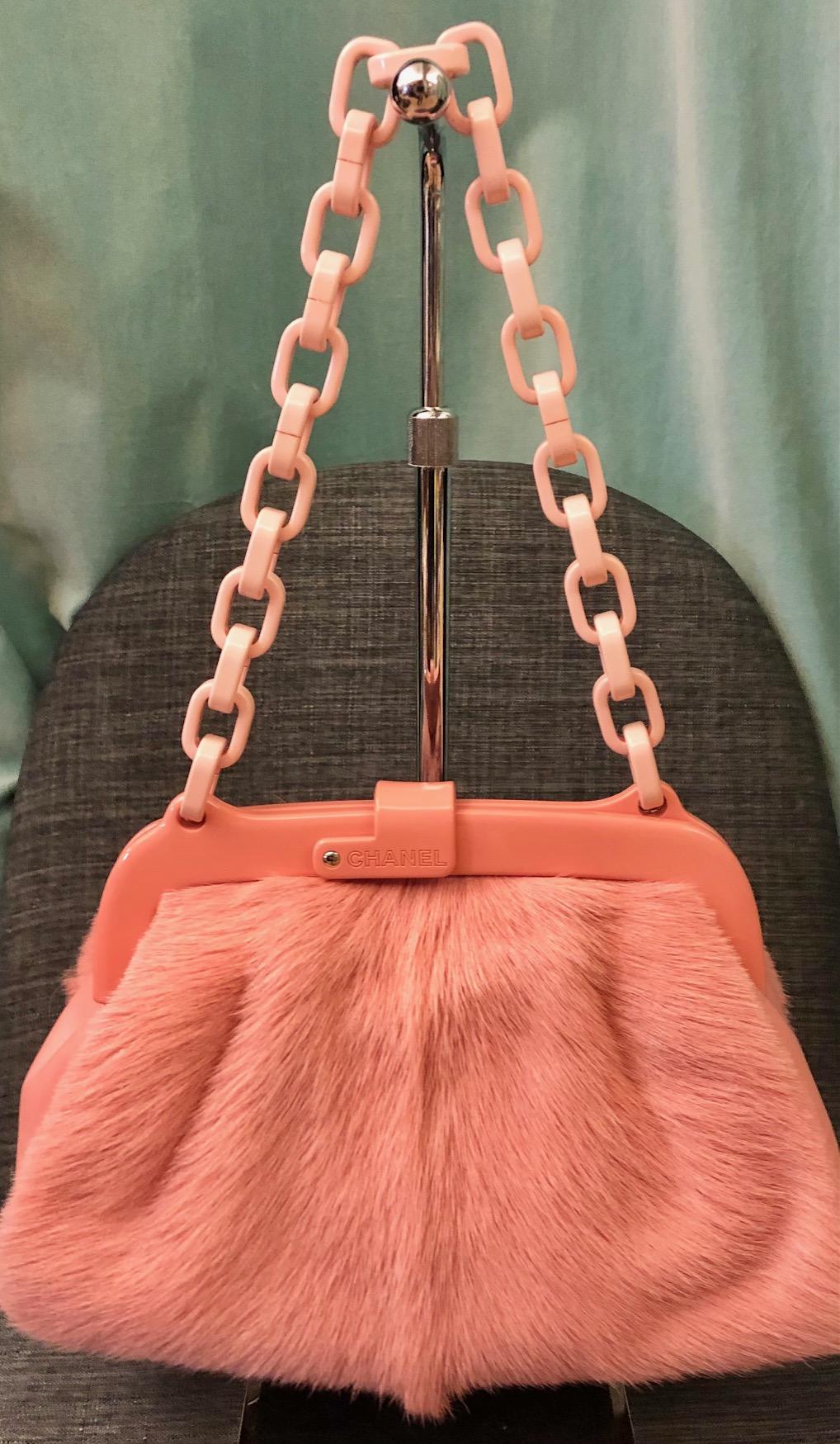 -  Chanel 2005-2006 Pink furry resin frame Bag. 

- Chanel pink pony hair purse with plastic resin frame, shoulder chain, and No 5 perfume bottle charm. 

- Comes with authenticity card, and sticker. 

- Length: 12 inches. Height: 16 inches. Width: