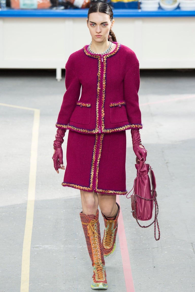 This pre-owned ensemble from the Fall 2014 Ready to Wear collection from Chanel was originally seen on the runway with a matching skirt.
Here we have the jacket in a beautiful dark pink tweed, lined with a colorful silk print. The blouse is crafted