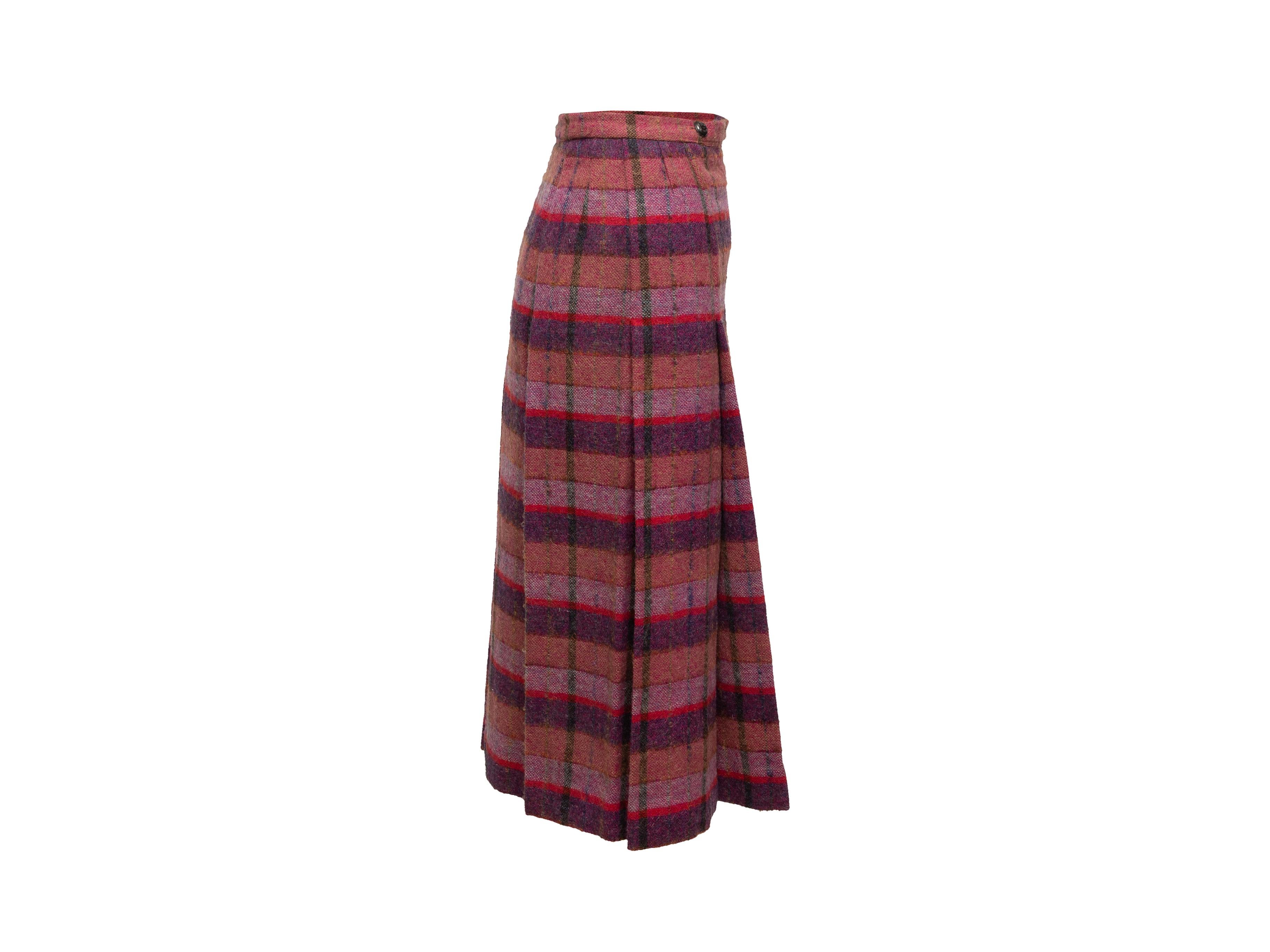 Product details: Vintage pink and purple wool pleated skirt by Chanel. Plaid pattern throughout. Button closures at front. 24