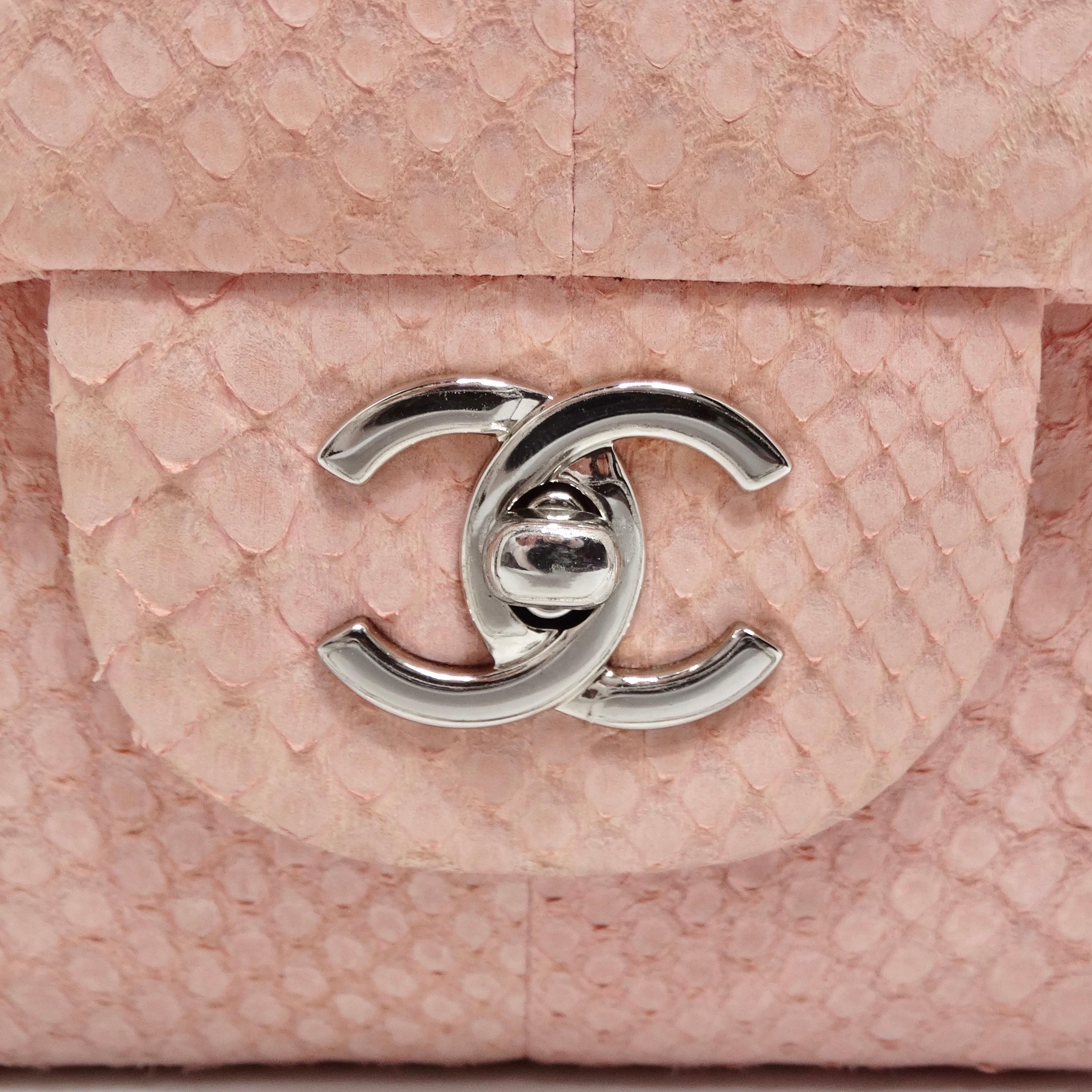 Introducing a collector's dream: the Chanel Pink Python Jumbo Double Flap Classic Bag. This exquisite piece of art is no longer in production, making it a highly sought-after and incredibly rare find. Crafted from genuine ballerina pink python skin,