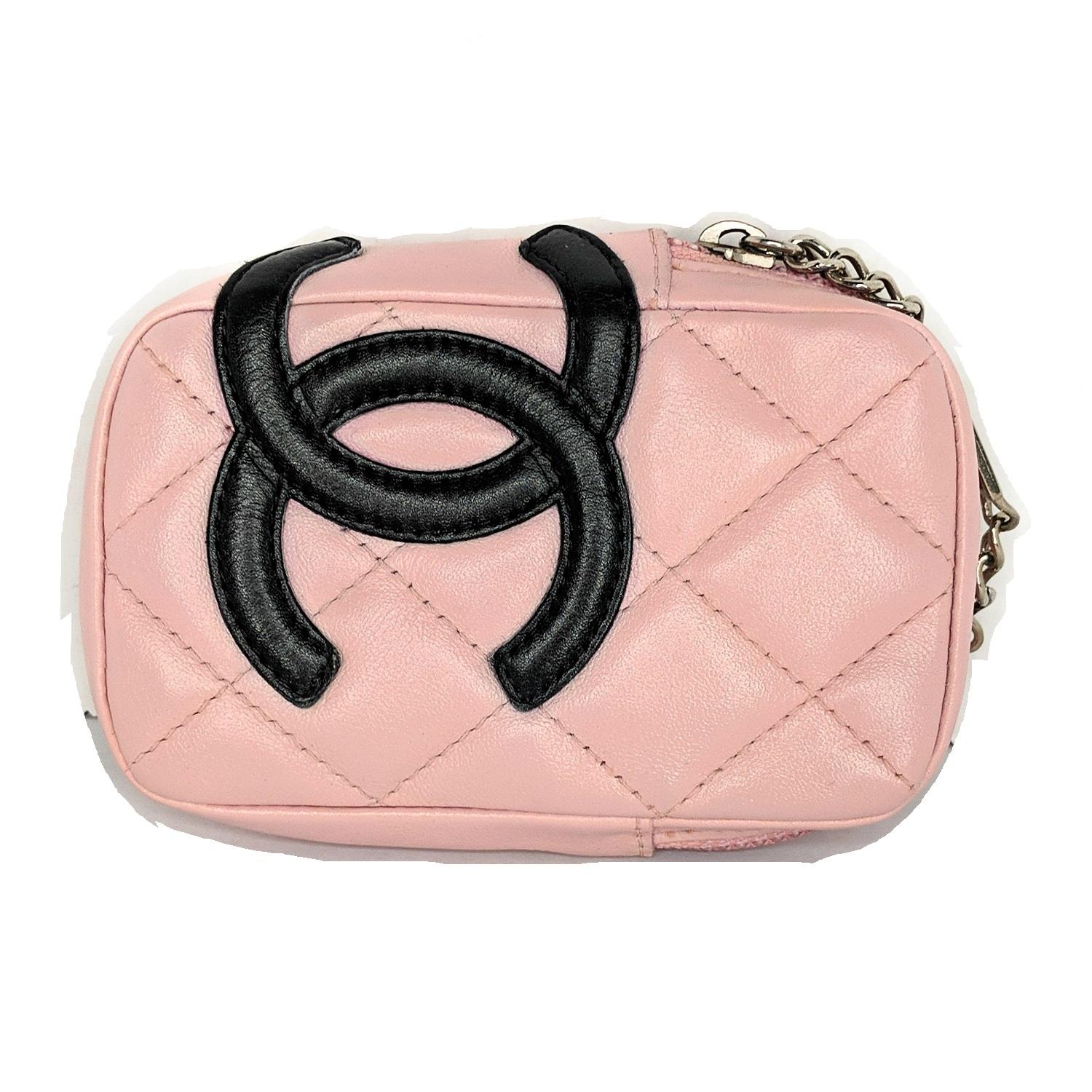 Pink quilted leather Chanel Mini Ligne Cambon Cosmetic Pouch with silver-tone hardware, interlocking CC logo at front, single exterior belt loop, pink logo jacquard lining and zip-around closure at top. Includes a complimentary dust