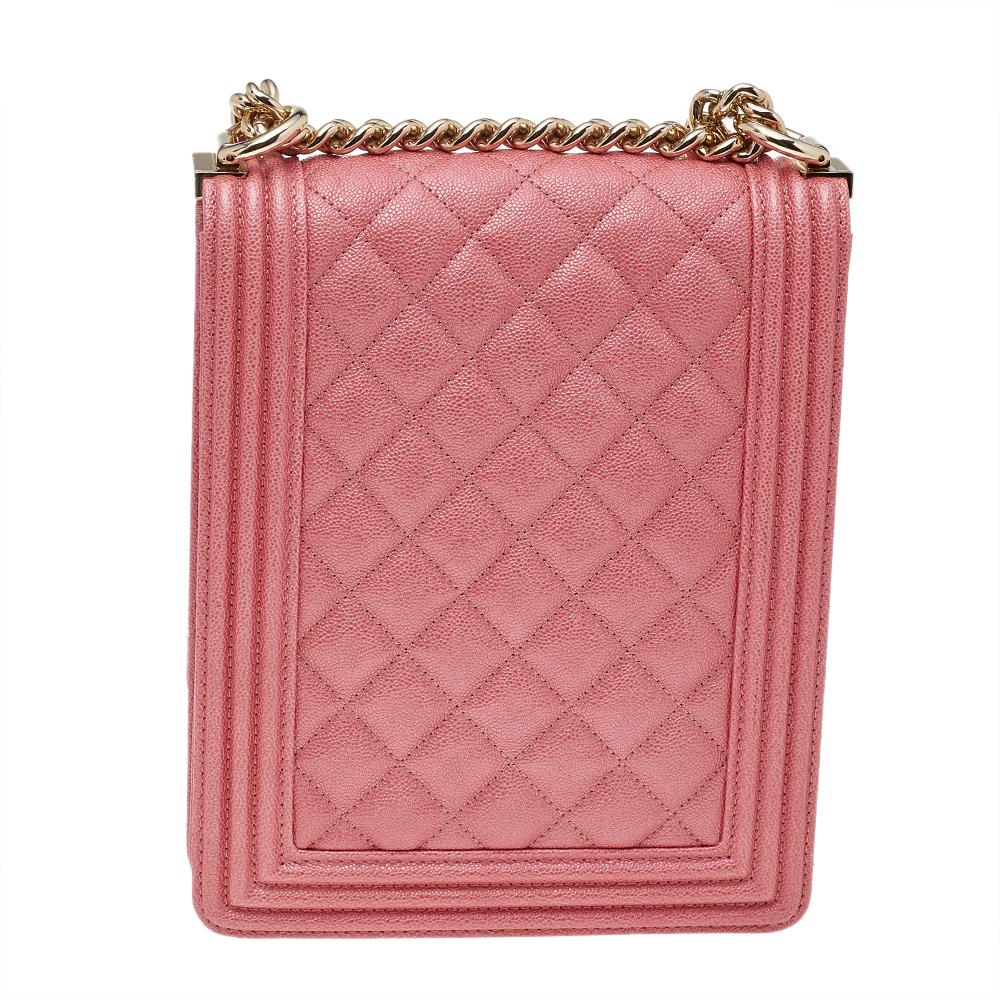 This Chanel North/South Boy bag is a chic update of the icon! The stunning bag is made from pink Caviar leather and has the everlasting quilted pattern. It features gold-tone hardware, the iconic Boy CC logo on the flap, and an adjustable