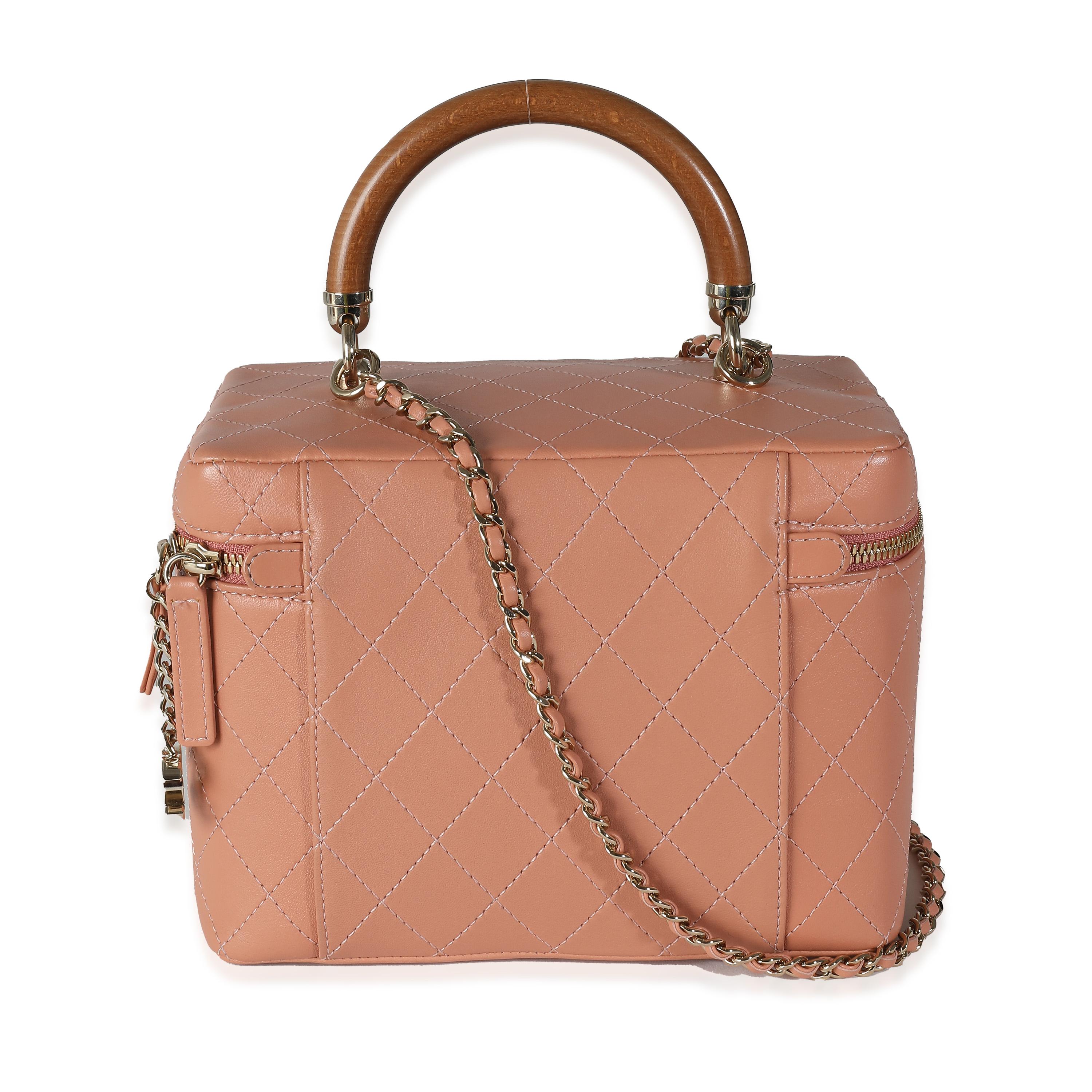 Listing Title: Chanel Pink Quilted Lambskin Knock On Wood Vanity Case
SKU: 141028
Condition: Pre-owned 
Handbag Condition: Excellent
Condition Comments: Item is in excellent condition and displays light signs of wear. Faint scratch along interior.