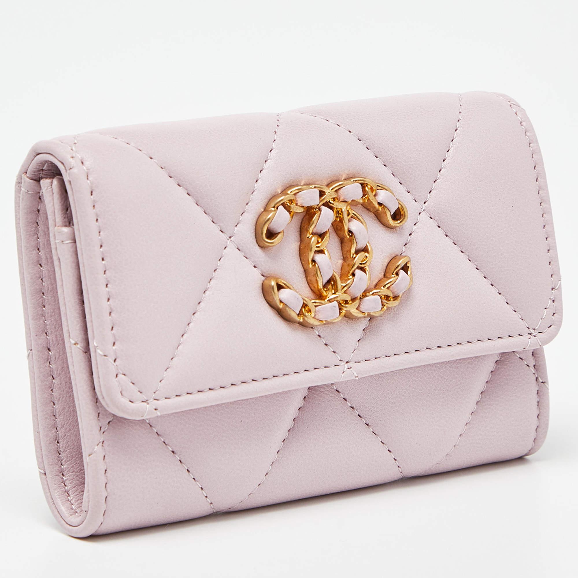 The Chanel 19 Card Case is a luxurious accessory crafted from soft, quilted leather in a stunning shade of pink. It features the iconic Chanel logo on the front and offers ample space for organizing cards while exuding elegance and sophistication.

