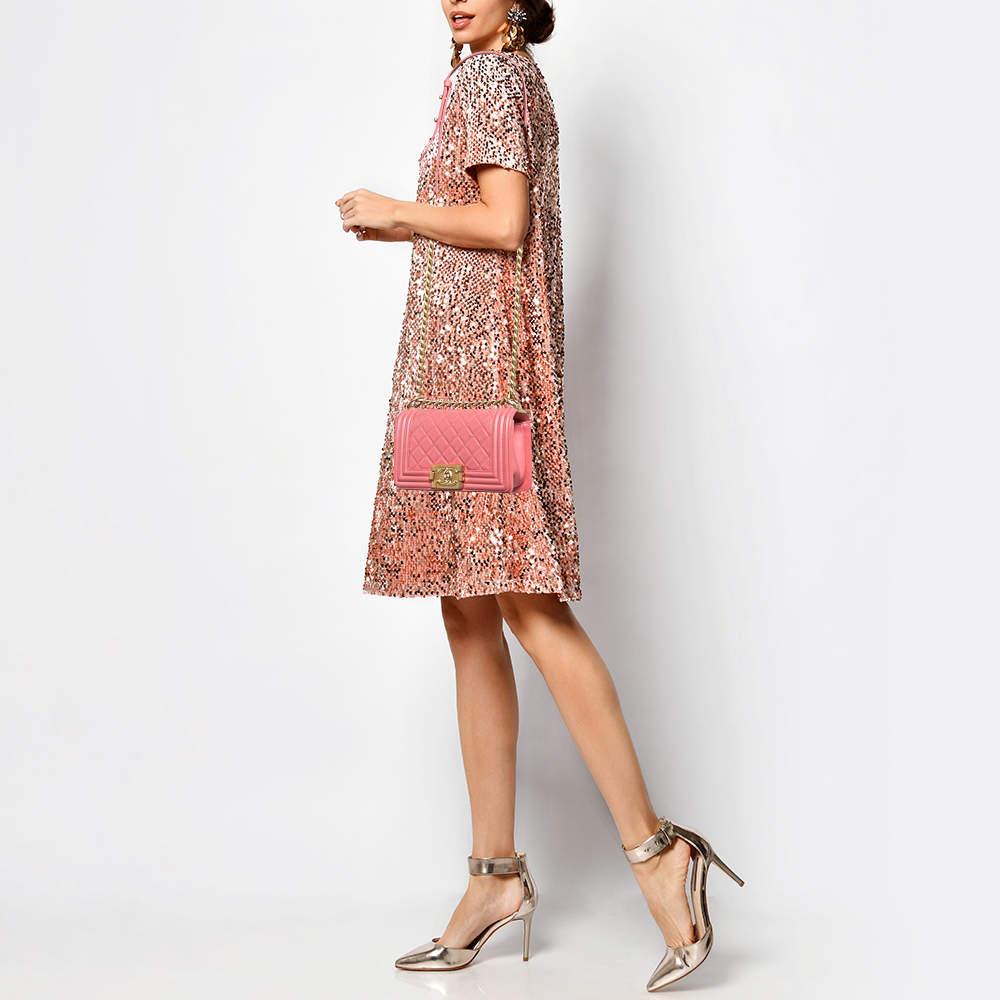 Introduced as a part of the Chanel Fall/Winter collection of 2011  the Boy flap bag embodies an alluring appeal and is complemented with exquisite details. This pink creation is meticulously crafted from quilted leather and features side paneling  a