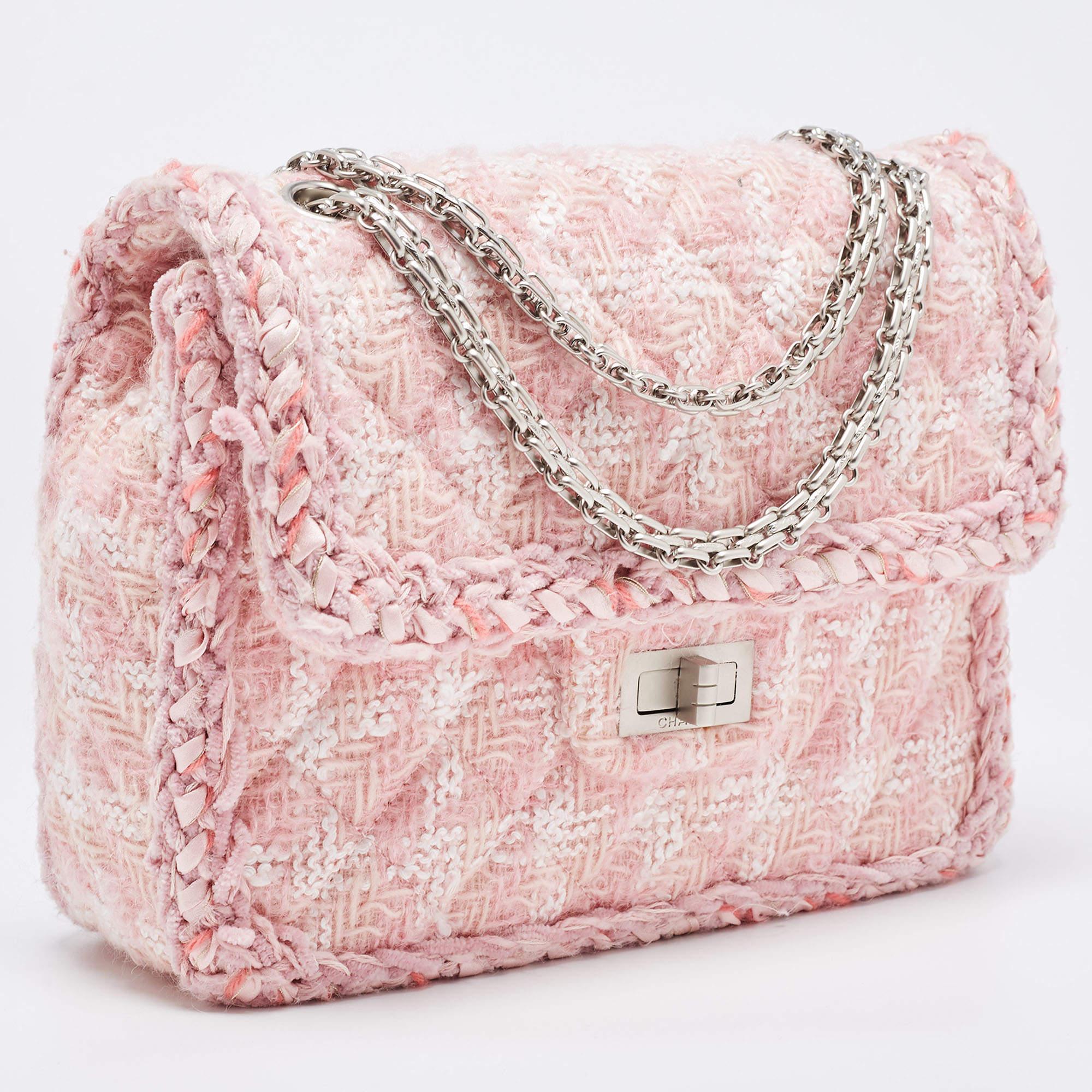 The Chanel Reissue 2.55 Flap Bag is an iconic fashion accessory. Crafted from luxurious pink tweed, it features the classic quilted pattern and a reissue lock. The square shape and chain strap make it a timeless and elegant addition to any outfit.


