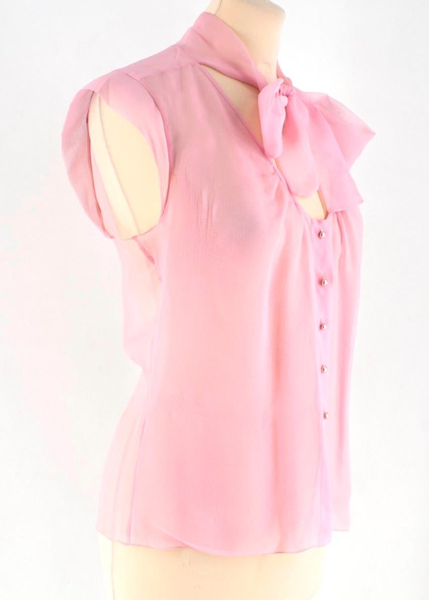 Chanel Pink Sheer Sleeveless Blouse

- Tie-neck
- Pearl buttons with Chanel logo
- Darts around the waist for shape
- Very lightweight and floaty

THERE IS NO SIZE LABEL, HOWEVER, BASED ON THE VIP SELLER'S USUAL SIZE AND OUR APPROXIMATE MEASUREMENTS