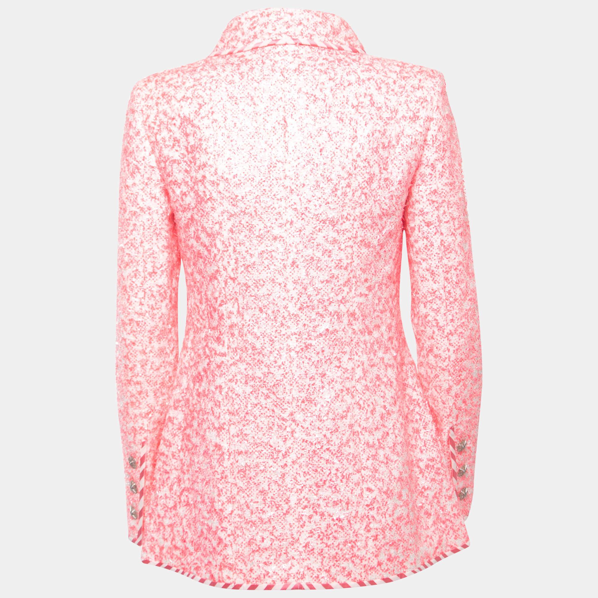The Chanel jacket is a chic and stylish outerwear piece. Crafted from high-quality synthetic material, it features a textured design in a soft pink hue. The jacket is adorned with a front zipper closure, making it easy to put on and take off. With