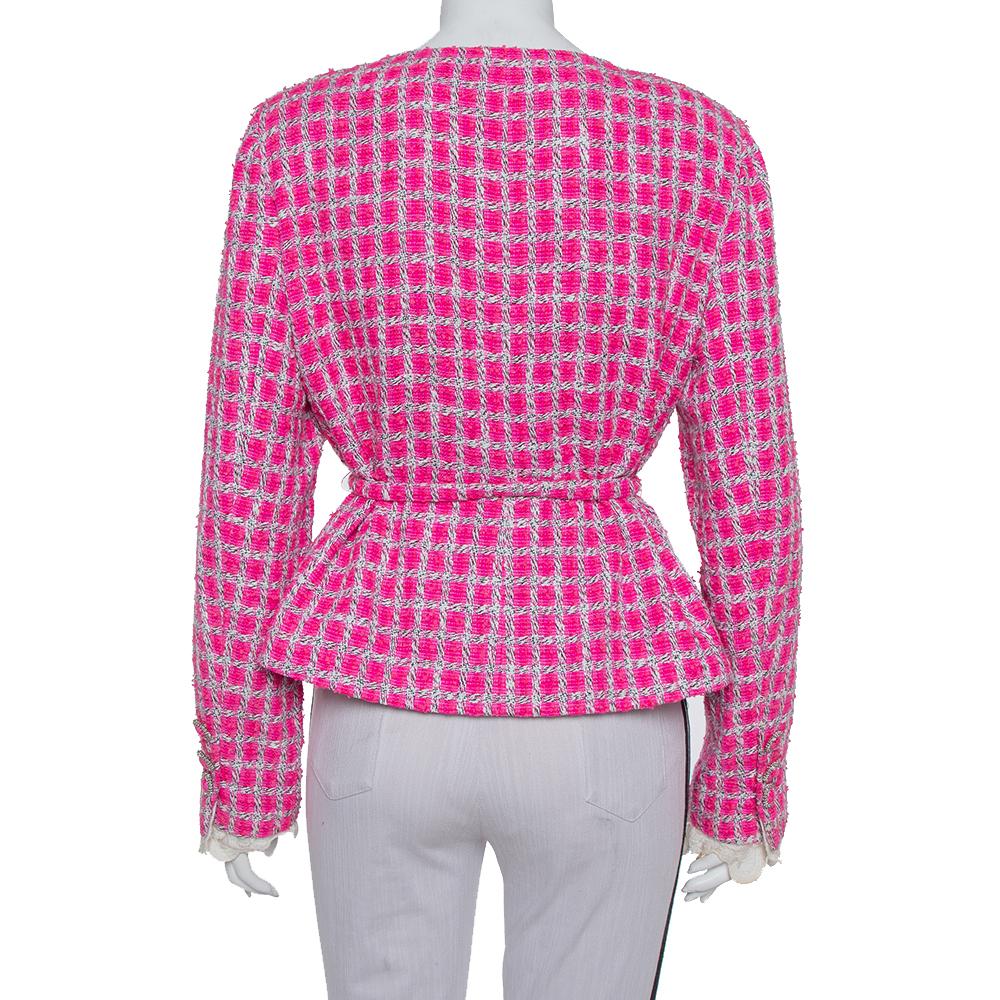 This Chanel jacket will be a dream addition to any woman's closet. This tweed creation not only carries a well-tailored silhouette but also stylish details like the round neckline and the lace trim hem on the sleeves. Lastly, the belt elevates the