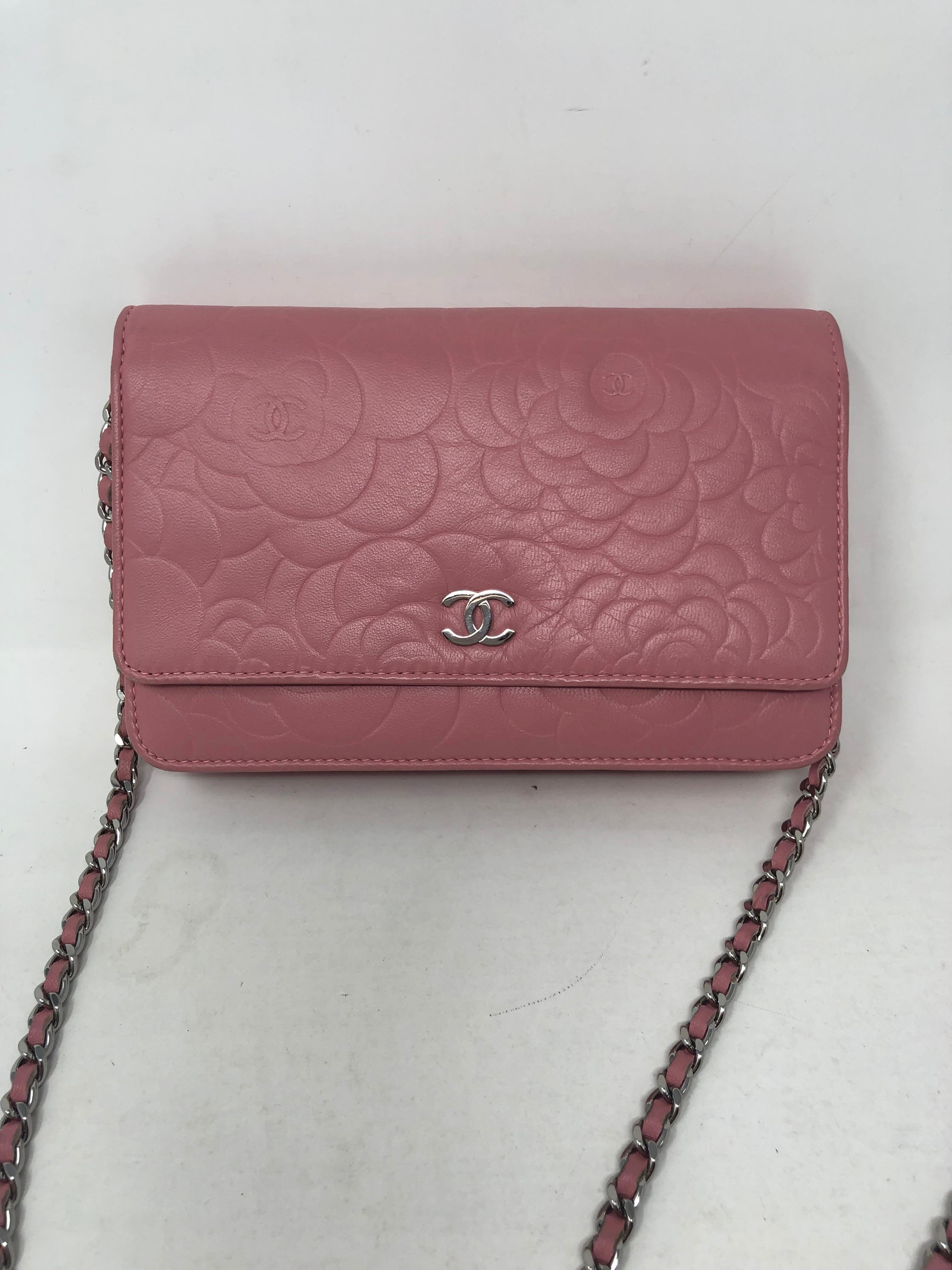 Chanel Pink Wallet On A Chain Crossbody Bag. Camelia leather embossed with silver hardware. Good condition. Can be worn as a clutch or a crossbody. Serial number inside bag. Guaranteed authentic. 