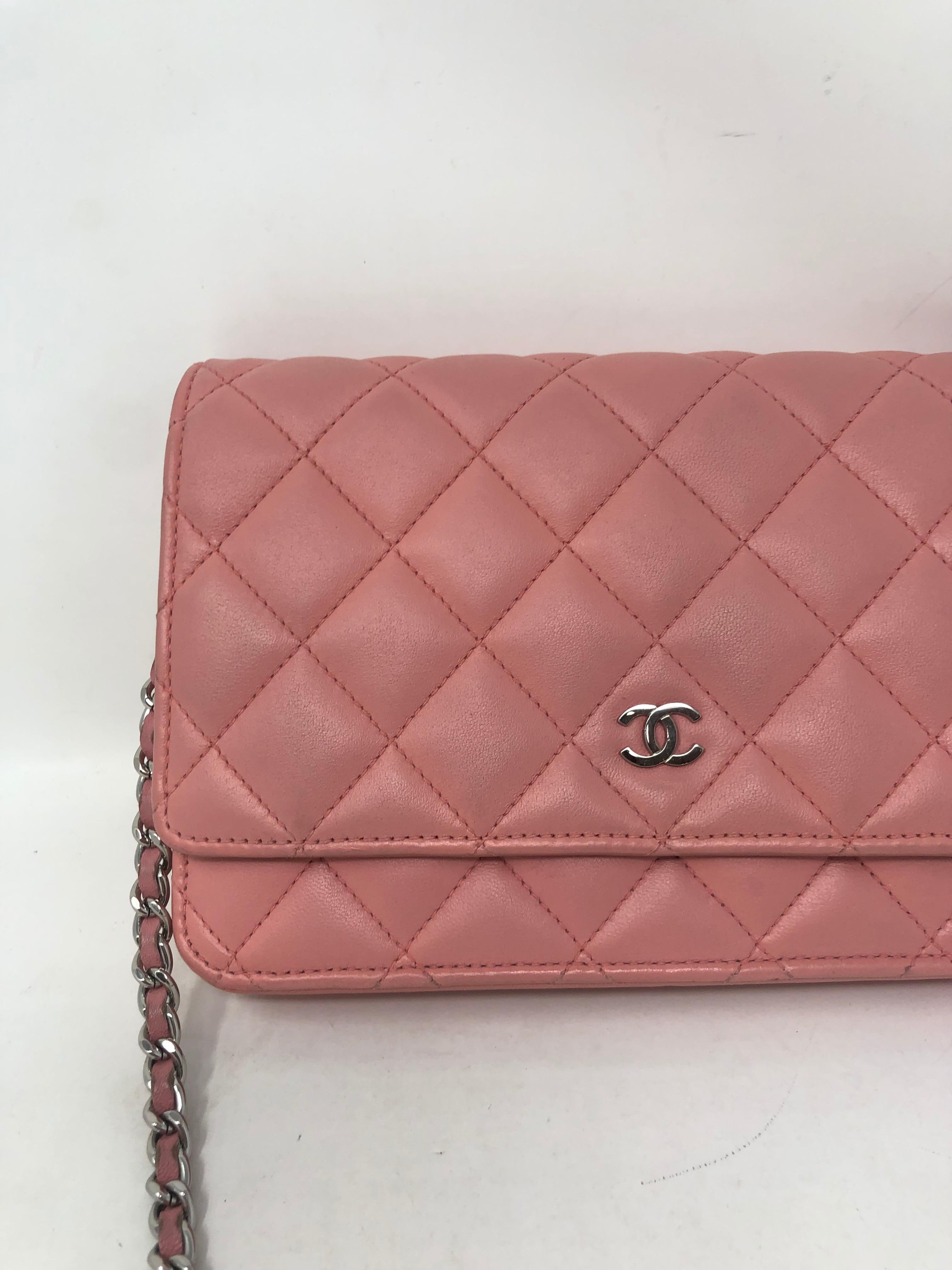 Chanel Pink Wallet On Chain. Pretty pale pink leather with silver hardware. Good condition. Can be worn as a clutch or as a crossbody bag. Includes authenticity card. Guaranteed authentic. 