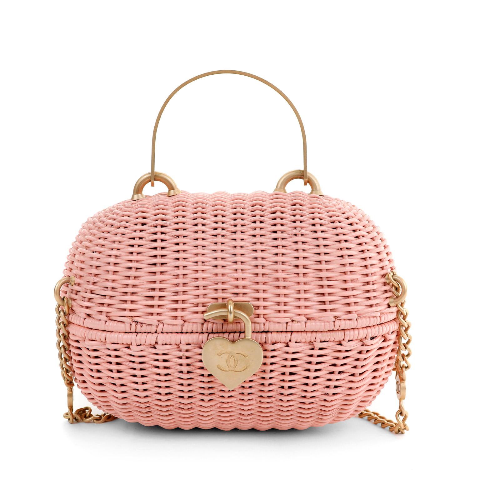 This authentic Chanel Pink Wicker Love Basket Bag is a runway piece in pristine condition.  Oval shaped pink wicker basket with top handle and hinged top. Matte gold heart shaped locket and chain strap.  Dust bag included.

PBF 13189