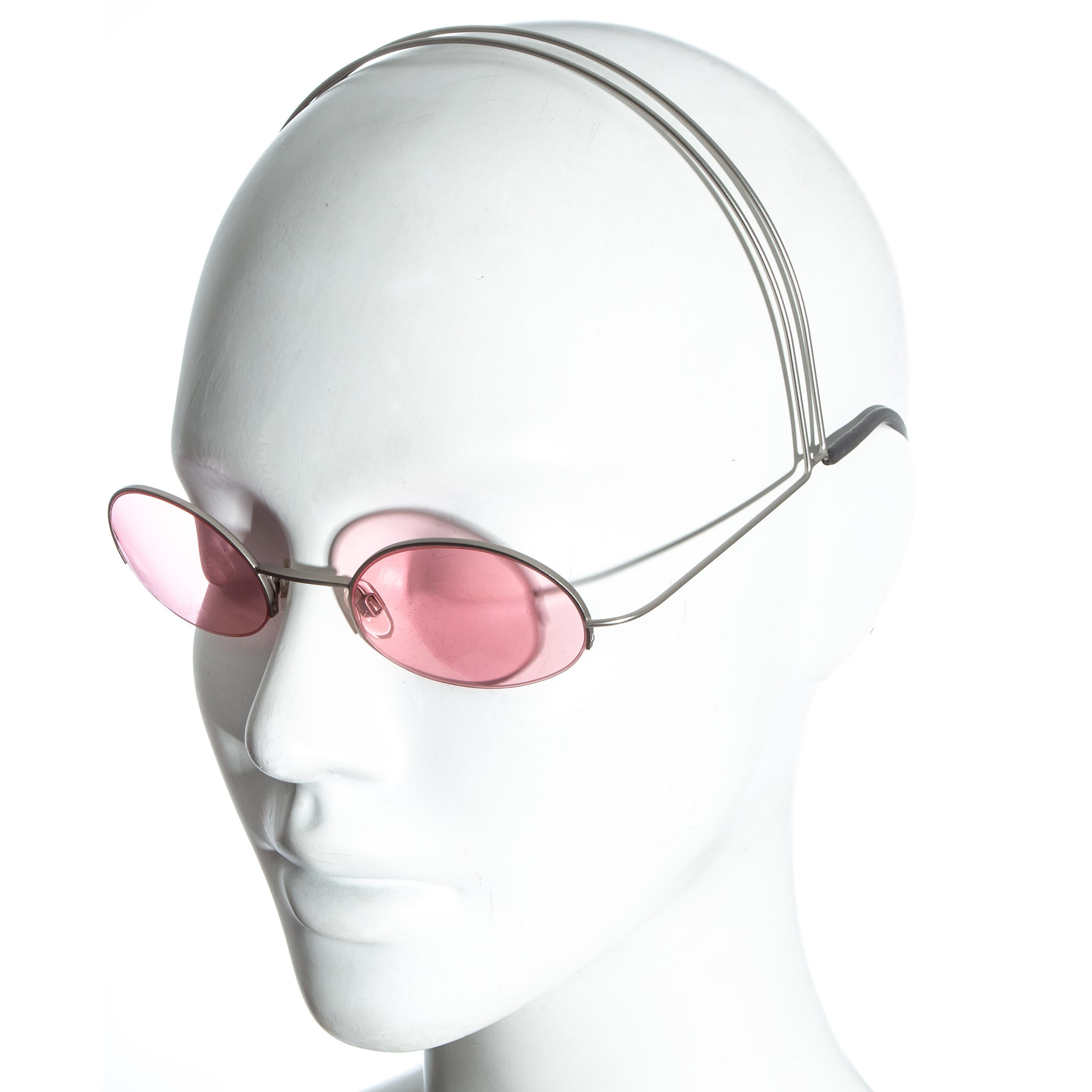Chanel pink sunglasses with silver wire headband and black rubber grips with chanel logo

Spring-Summer 1999
