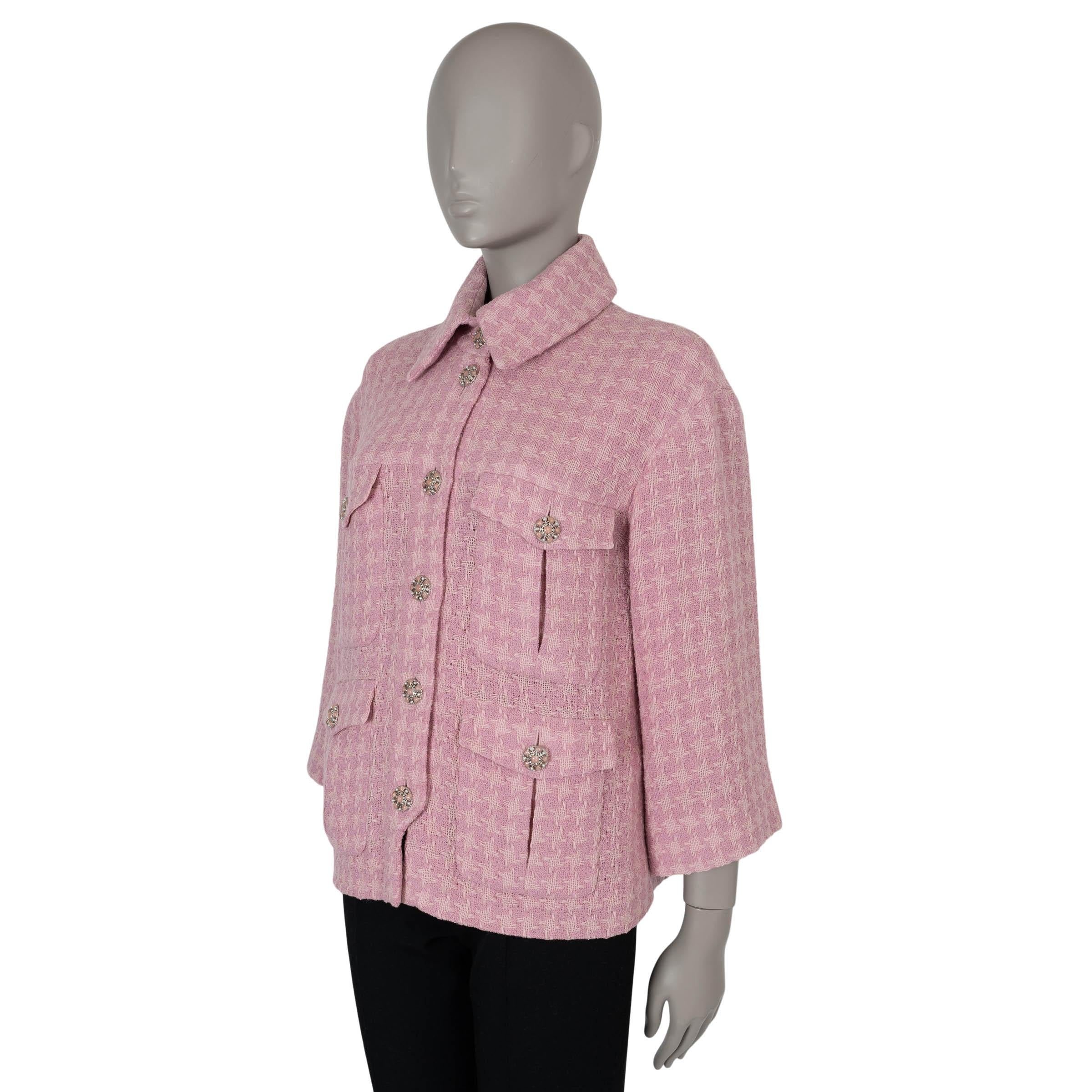 This 100% authentic Chanel houndstooth tweed jacket in pale pink wool (100%) exudes elegance and sophistication. Features include four buttoned flap pockets on the front, 7/8 sleeves, and pearl and pink stone-embellished 'CC' buttons for a refined